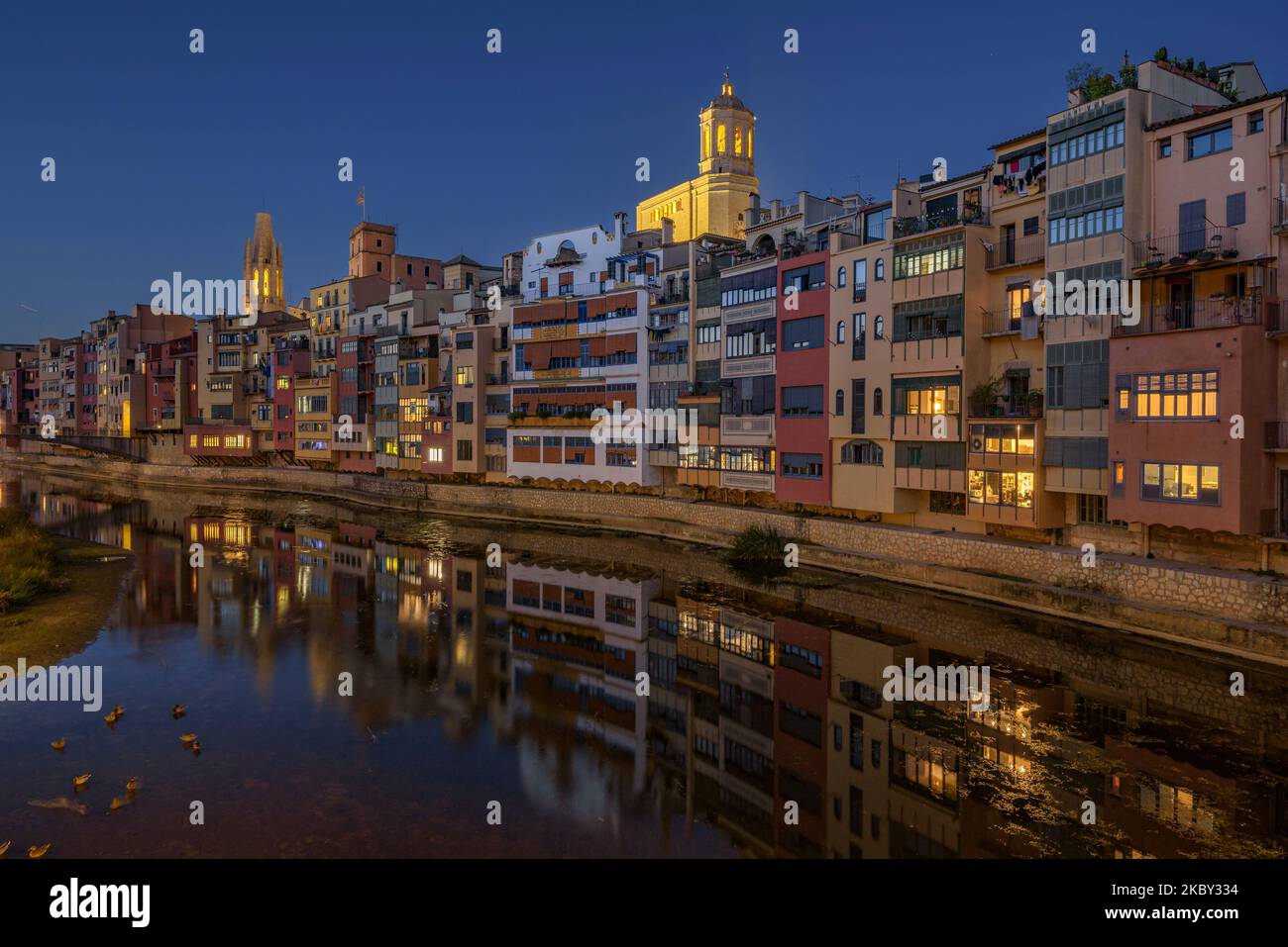 Häuser neben dem Fluss Onyar, der zur blauen Stunde und Nacht durch die Stadt Girona führt (Girona, Katalonien, Spanien) ESP: Casas sobre el Río Onyar Stockfoto