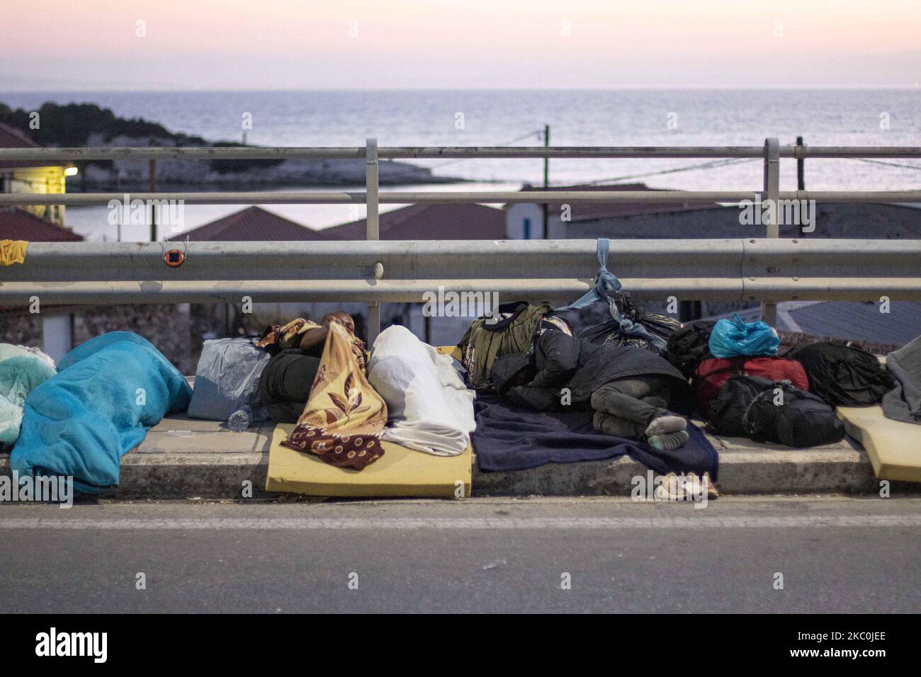 Flüchtlinge und Migranten schlafen auf der Straße. Am frühen Morgen schlafen mehr als 10,000 Asylsuchende nach dem Brand im Moria-Flüchtlingslager, dem Hotspot-Zentrum für Identifikation und Registrierung, am Straßenrand. Obdachlose Flüchtlinge und Migranten ohne Unterkünfte oder Einrichtungen wie Toiletten oder fließendes Wasser leben auf der Straße zwischen Mytilene oder Mitlini Stadt, der Hauptstadt der Insel und Moria, in der Nähe von Caratepe, was die Hauptstraße der Insel zu schließen, In provisorischen Zelten, da es zu dieser Zeit keinen Platz für sie gab, wurde später das neue provisorische Kara Tepe- oder Mavrovouni-Flüchtlingslager errichtet. Stockfoto