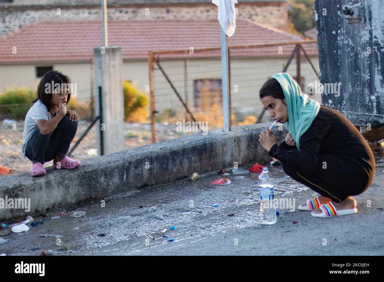 Zahnbürsten früh morgens in der Nähe der Mülltonne, während Flüchtlinge auf der Straße leben. Am frühen Morgen schlafen mehr als 10,000 Asylsuchende nach dem Brand im Moria-Flüchtlingslager, dem Hotspot-Zentrum für Identifikation und Registrierung, am Straßenrand. Obdachlose Flüchtlinge und Migranten ohne Unterkünfte oder Einrichtungen wie Toiletten oder fließendes Wasser leben auf der Straße zwischen Mytilene oder Mitlini Stadt, der Hauptstadt der Insel und Moria, in der Nähe von Caratepe, was die Hauptstraße der Insel zu schließen, In provisorischen Zelten, da es zu dieser Zeit keinen Platz für sie gab, später die neue temporäre Kara Tepe oder Mavr Stockfoto
