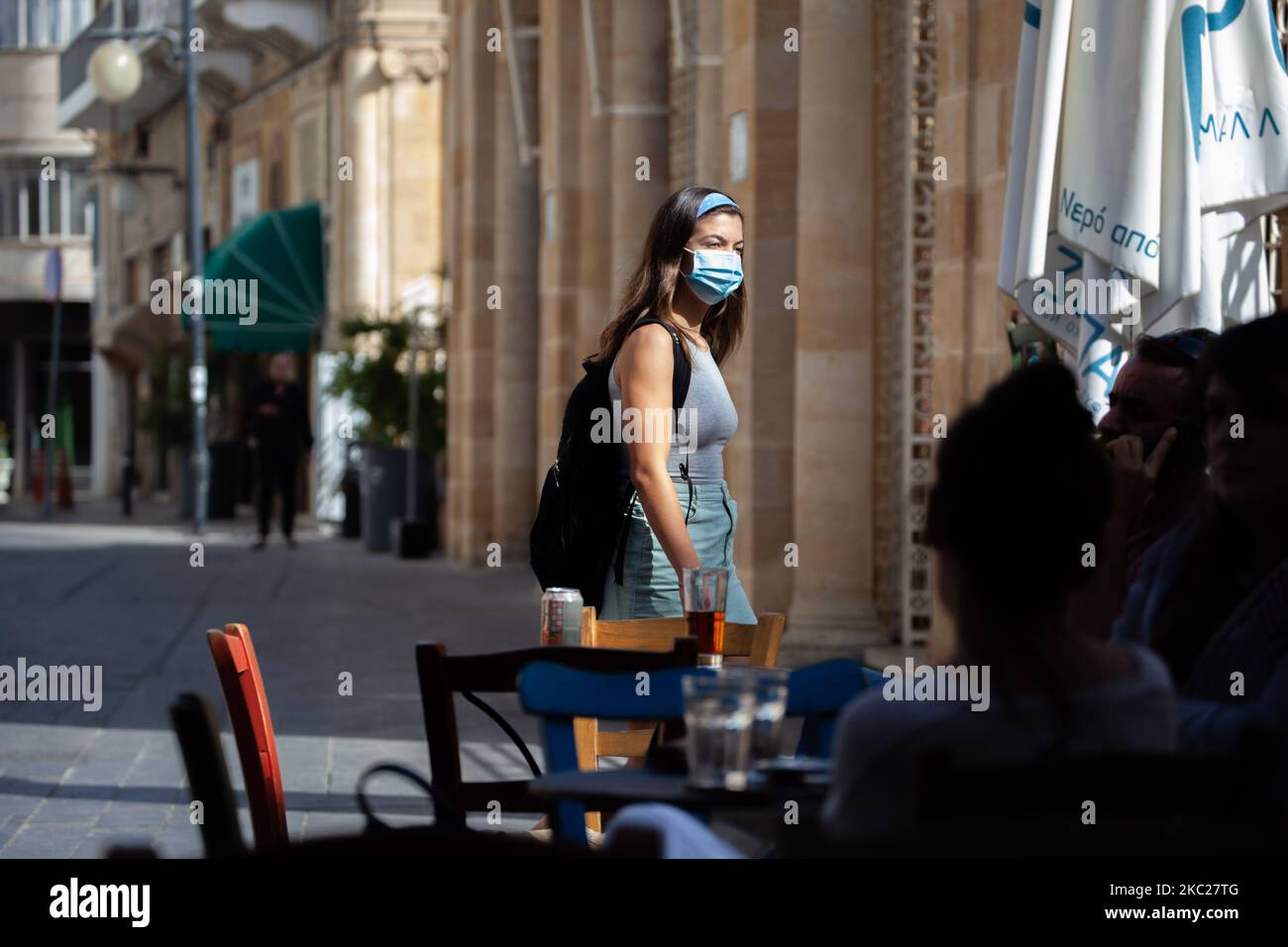 Eine Frau mit Schutzmaske, die am 20. Oktober 2020 in der Altstadt von Nikosia, Zypern, zu Fuß unterwegs ist (Foto: George Christophorou/NurPhoto) Stockfoto