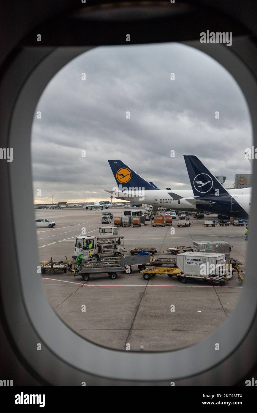 Tail Lineup, eine Reihe von Lufthansa-Flugzeugen mit dem Logo, das von einem Flugzeugfenster am FRA des Internationalen Flughafens Frankfurt aus gesehen werden kann. Der ehemalige deutsche Flaggenträger verfügt dort über die größte Drehkreuz-Basis. Die Deutsche Lufthansa AG ist die größte deutsche Airline-Fluggesellschaft, die zweitgrößte Passagierin Europa und Mitglied der Luftfahrtallianz Star Alliance. Die Marke verwendet den Kranichvögel in einem Kreis als Logo, ein Symbol, das im Laufe der Jahre kürzlich von gelb auf weiß in blau umfirmiert wurde. Der Frankfurter Flughafen ist mit 4. in Europa und 13. weltweit der verkehrsreichste Flughafen in Deutschland. Frankfurt, Deutschland am 2020. März (Pho Stockfoto