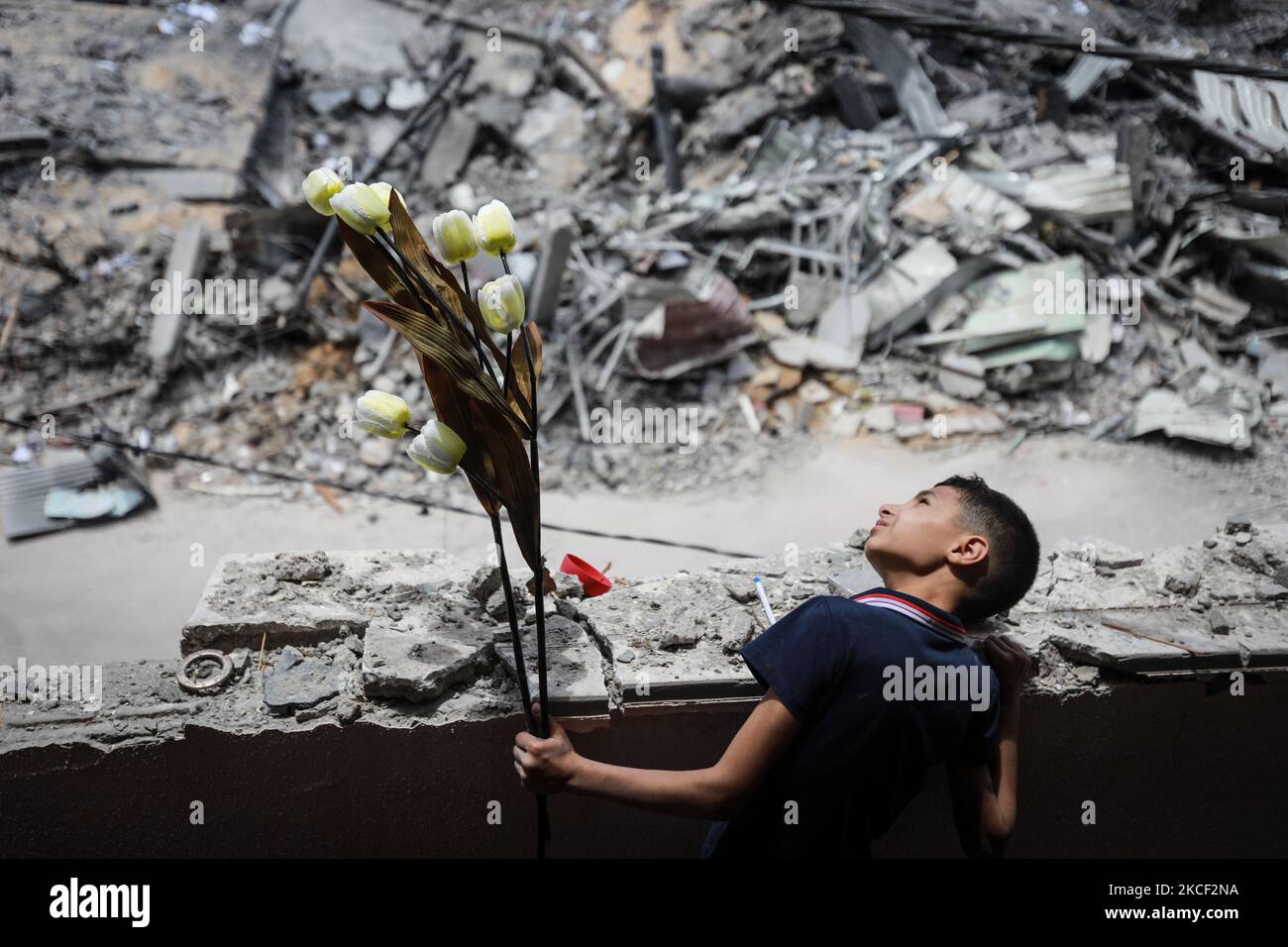 Ein palästinensischer Junge inspiziert am 22. Mai 2021 in Gaza-Stadt die Trümmer von Gebäuden, die durch israelische Angriffe zerstört wurden. - Eine Waffenruhe im Konflikt zwischen Israel und palästinensischen Militanten im Gazastreifen, die von der islamistischen Gruppe Hamas kontrolliert wird, trat nach 11 Tagen Luftangriffe und Raketenbeschuss in Kraft. (Foto von Majdi Fathi/NurPhoto) Stockfoto