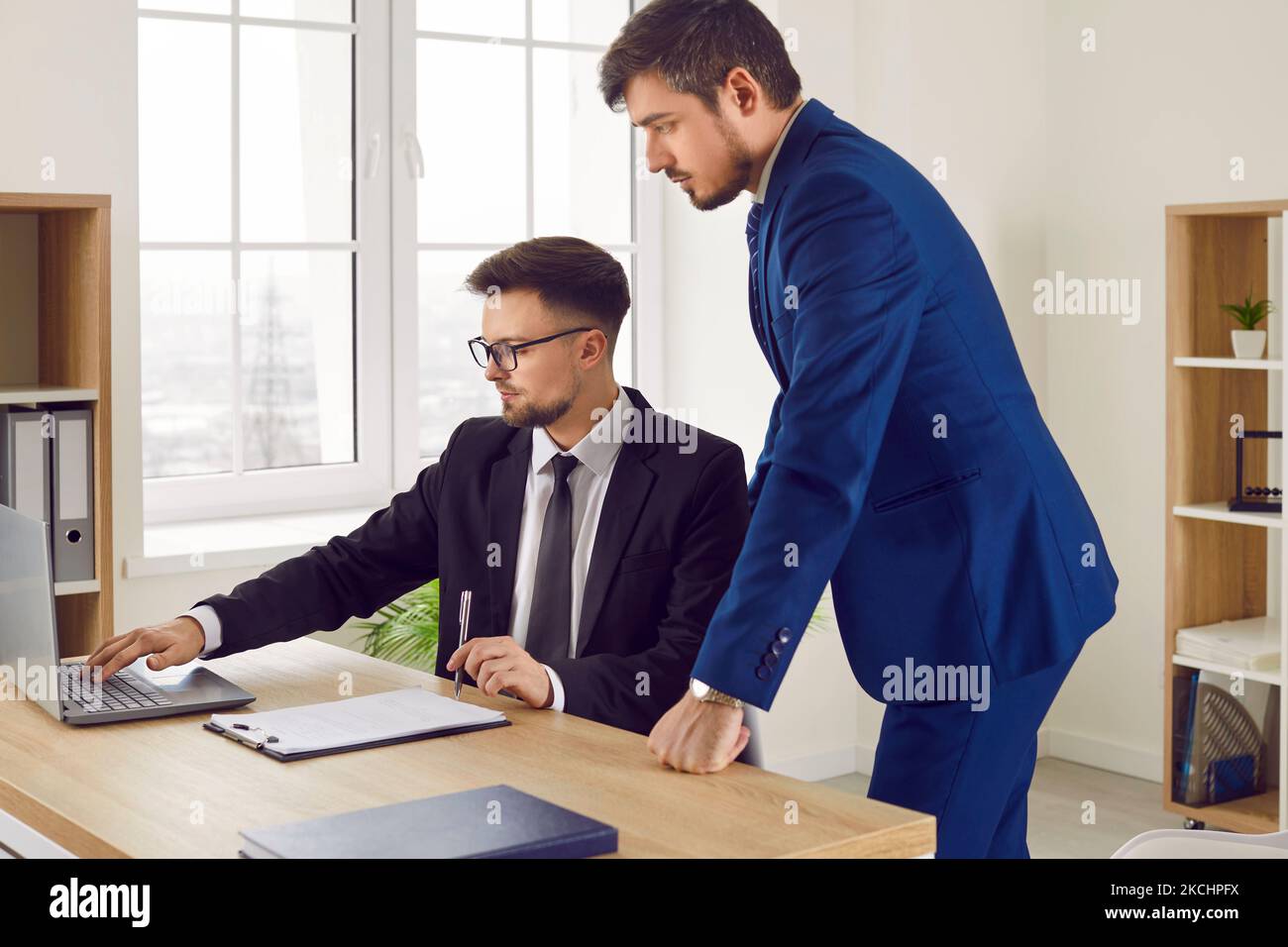Männliche Kollegen bei der Arbeit im Büro sprechen während der Zusammenarbeit an einem gemeinsamen Geschäftsprojekt. Stockfoto