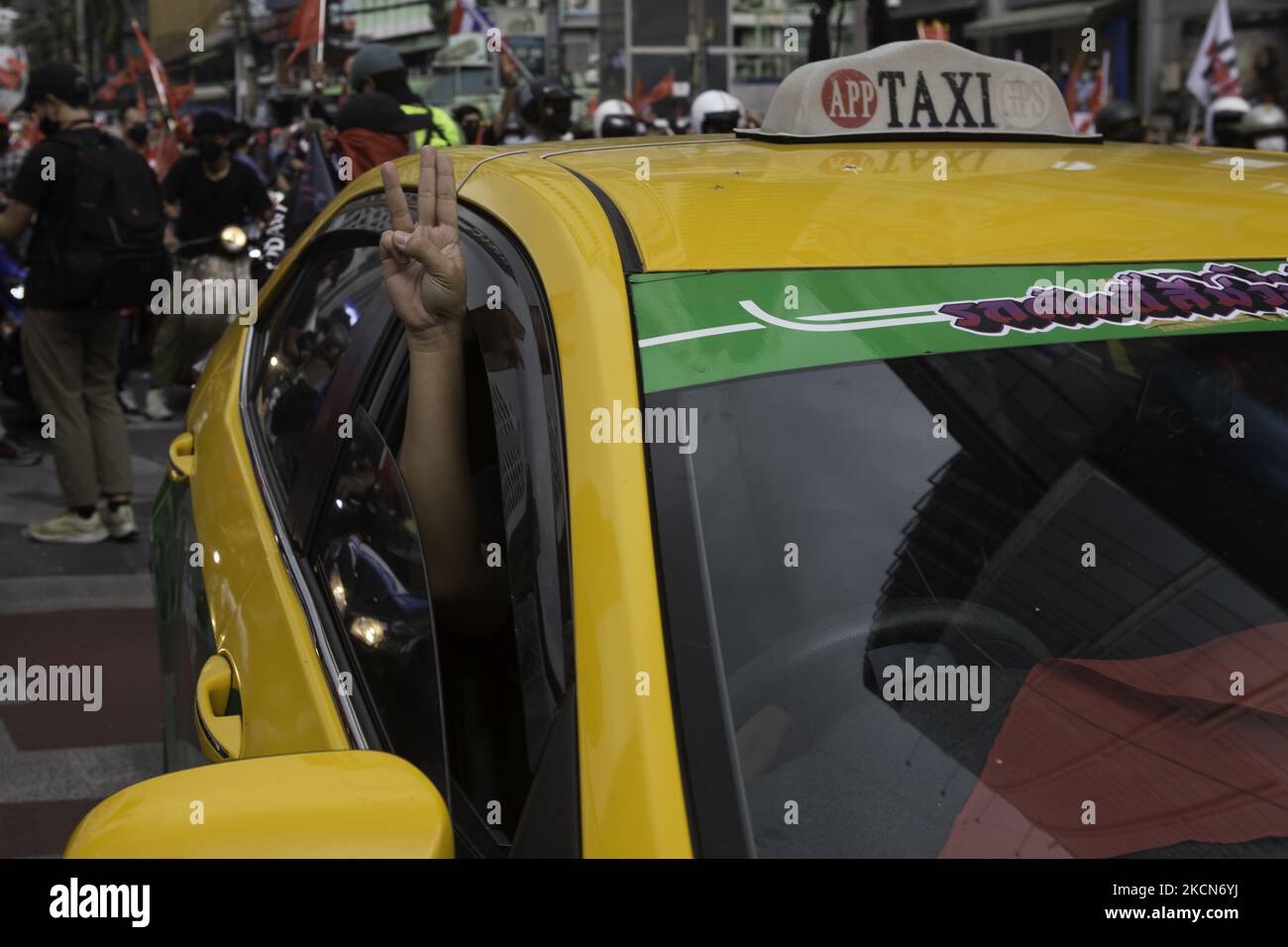 Der Taxifahrer hielt das drei-Finger-Symbol hoch, bevor er am Sonntag bei Asoke-Intersetion eine Anti-Putsch- und Anti-Regierungskundgebung anstoss. Regierungsfeindliche Demonstranten in Bangkok, Thailand, am 19. September 2021, während einer Demonstration anlässlich des 15-jährigen Jubiläums seit der militärischen Übernahme von 2006 in Bangkok am 19. September 2021, als sie den Rücktritt der aktuellen Regierung wegen ihres Umgangs mit der Coronavirus-Krise von Covid-19 forderten. (Foto von Atiwat Silpamethanont/NurPhoto) Stockfoto