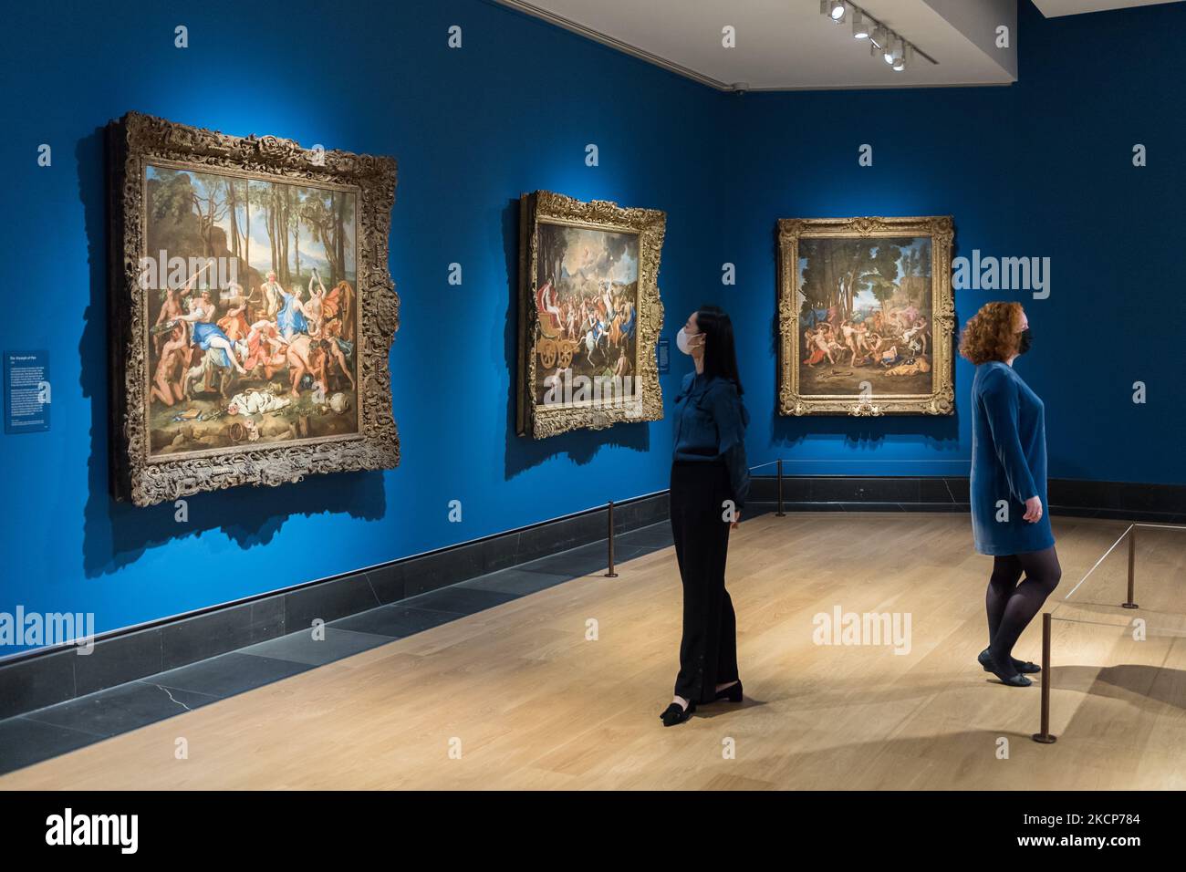LONDON, GROSSBRITANNIEN - 07. OKTOBER 2021: Mitarbeiter der Galerie betrachten Gemälde mit den Titeln (L-R) 'The Triumph of Pan' (1636), 'The Triumph of Bacchus' (1635-6) und 'The Triumph of Silenus' (c. 1636) des französischen Klassikers Nicolas Poussin (1594–1665) während einer Presseinterview zur bevorstehenden Ausstellung „Poussin and the Dance“ (9. Oktober 2021 – 2. Januar 2022) in der National Gallery, am 07. Oktober 2021 in London, England. (Foto von Wiktor Szymanowicz/NurPhoto) Stockfoto