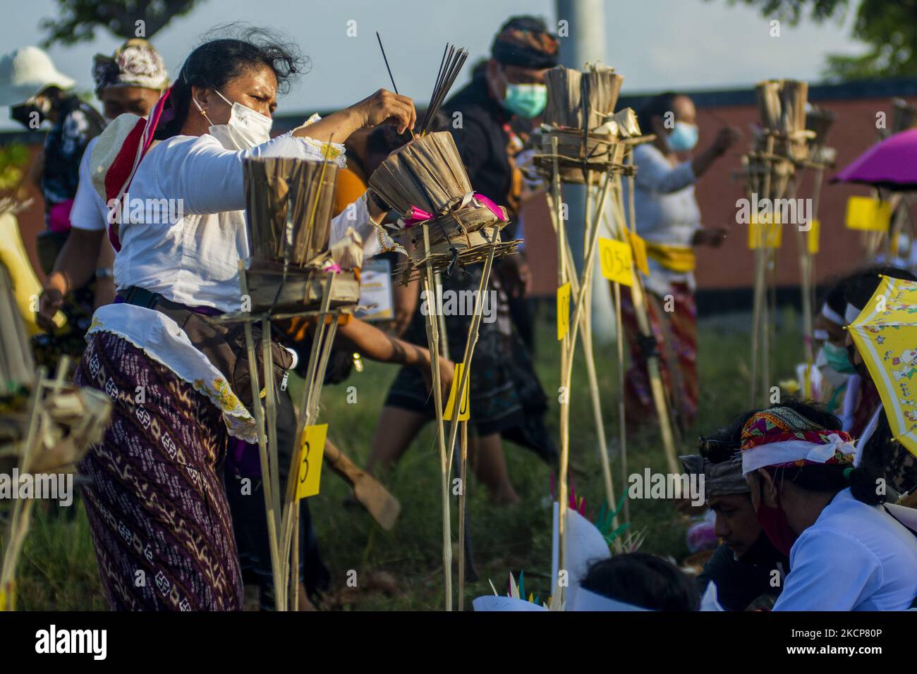 Religiöse Beamte organisieren am 7. Oktober 2021 bei der Ngaben Ngerit Zeremonie im Prajapati Tempel, Palu, Provinz Zentral-Sulawesi, Indonesien, Opfergaben, bevor das rituelle Gebet abgehalten wird. Die Massenzeremonie von Ngaben, an der 36 sawo (geweihte Körper), darunter eine Reihe von COVID-19 Opfern, beteiligt waren, sollte Geistern den Körper an seinen ursprünglichen Platz zurückbringen, nachdem er zuvor begraben oder eingeäschert worden war. (Foto von Basri Marzuki/NurPhoto) Stockfoto