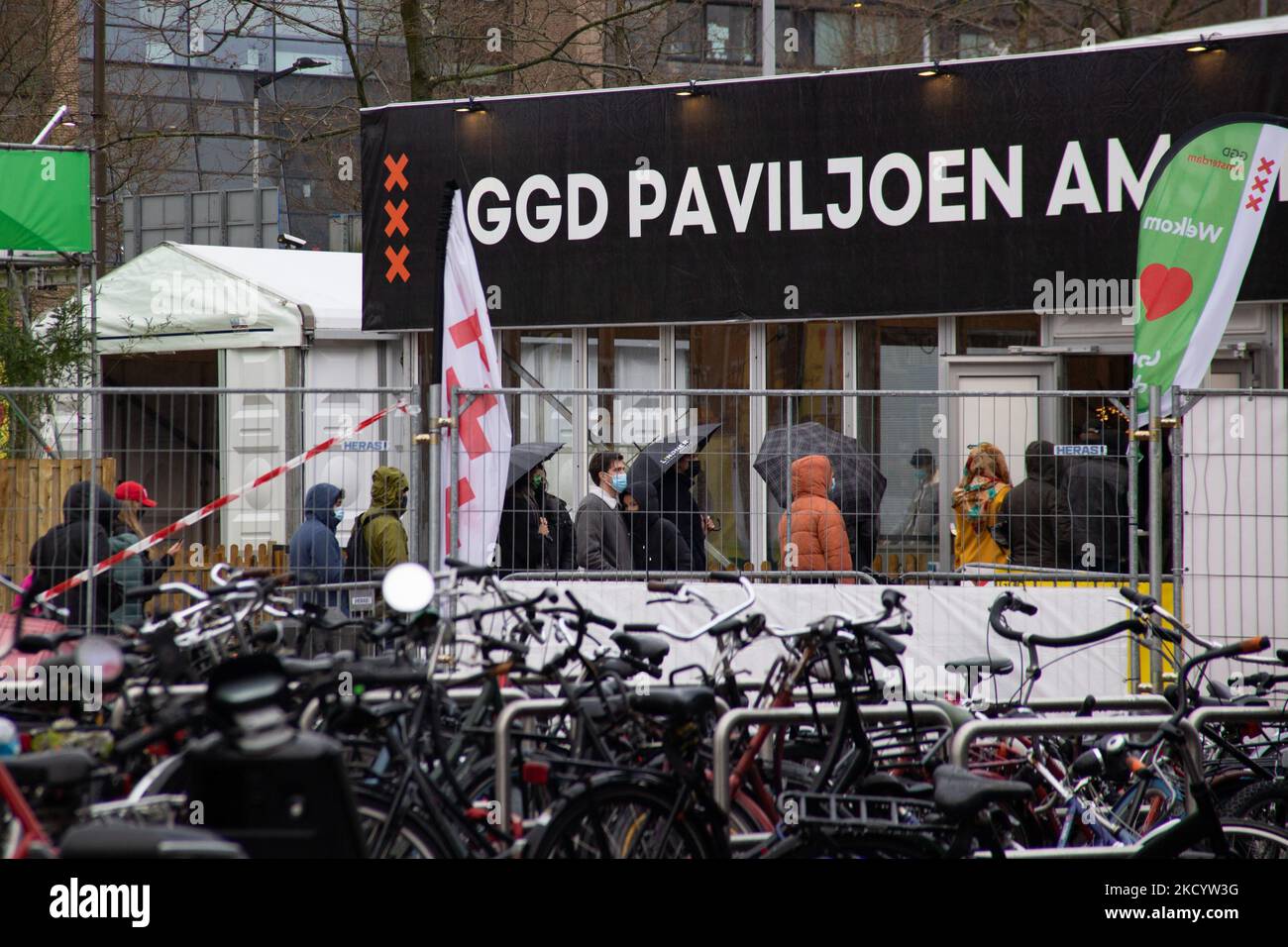 Menschen mit Gesichtsmasken warten vor einer Einrichtung des GGD Paviljoen Amsterdam Covid-19-Testzentrums, um getestet zu werden, GGD ist der städtische Gesundheitsdienst in Amsterdam Zuid. Die Niederlande waren die erste europäische Nation, die kurz vor Weihnachten während der Coronavirus-Pandemie von Covid-19 eine Sperre gegen die neue Omicron-Variante ausrief. Bars, Fitnessstudios, Friseure und alle „nicht notwendigen“ Geschäfte, Museen, öffentlichen Einrichtungen usw. waren bis mindestens Januar 14 geschlossen. Amsterdam, Niederlande am 5. Januar 2022 (Foto von Nicolas Economou/NurPhoto) Stockfoto