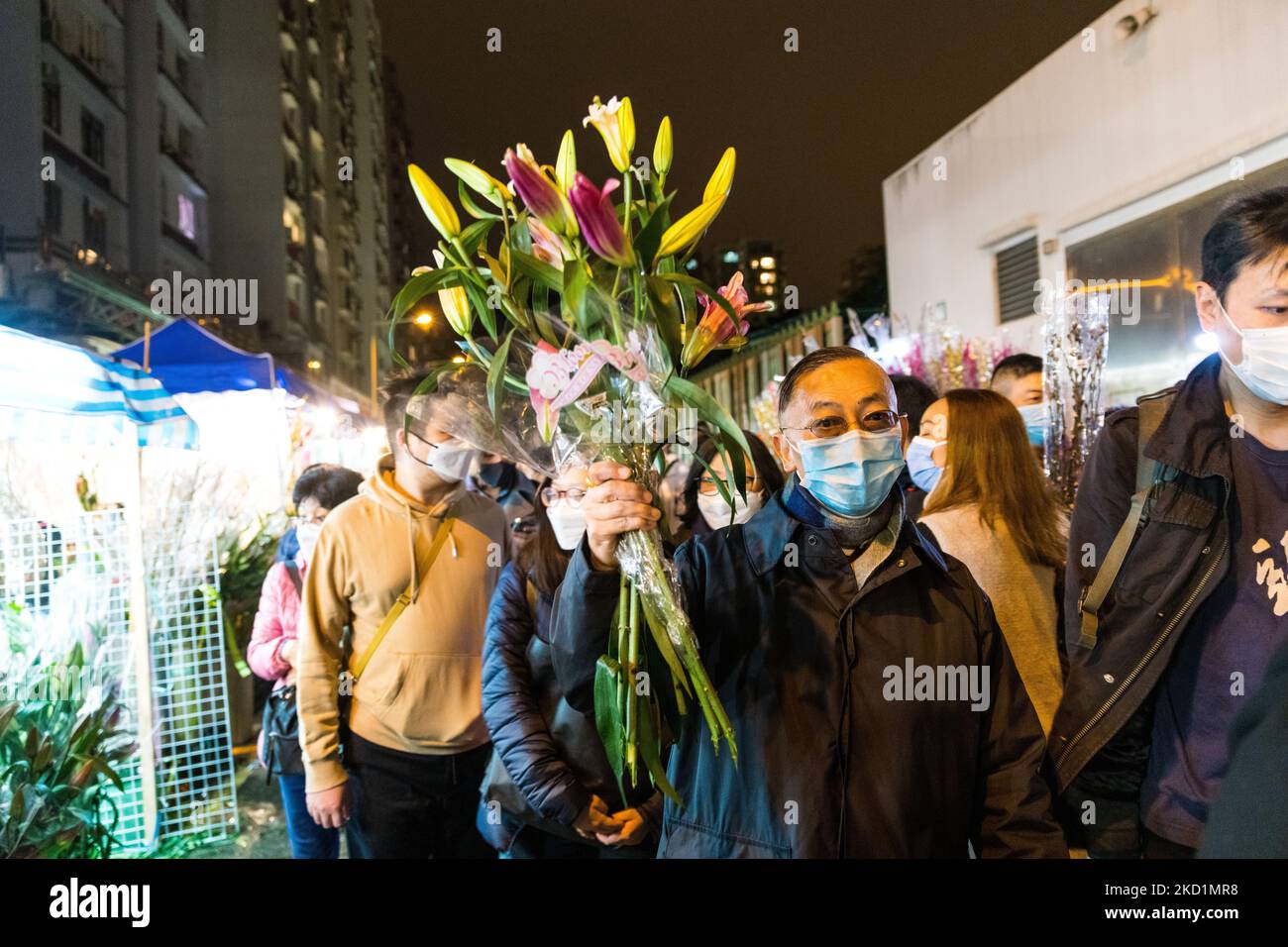 Ein Mann hält einen Blumenstrauß, den er gerade am 31. Januar 2022 auf dem Mongkok Blumenmarkt gekauft hat. (Foto von Marc Fernandes/NurPhoto) Stockfoto