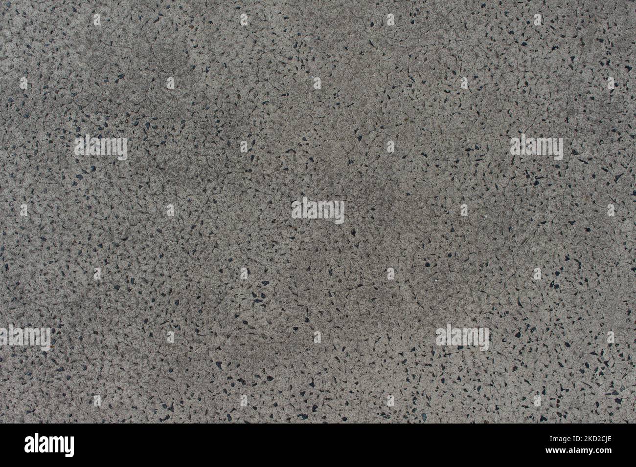 Top-Down-Aufnahme des Punktmusters mit glatter grauer Pflasterstruktur Stockfoto