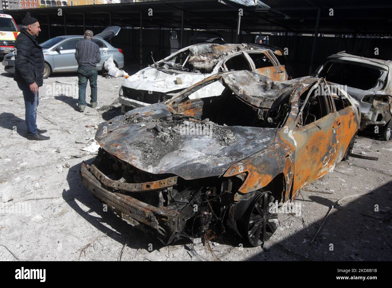 Männer inspizieren zerstörte Autos, nachdem am 24. April 2022 in Odesa, Ukraine, ein Wohnhaus von einem Raketenangriff getroffen wurde. Am 23. April berichteten ukrainische Beamte, dass Russland sechs Raketen auf Odesa abgefeuert habe und dabei mindestens acht Menschen, darunter ein Baby, getötet habe. (Foto von STR/NurPhoto) Stockfoto
