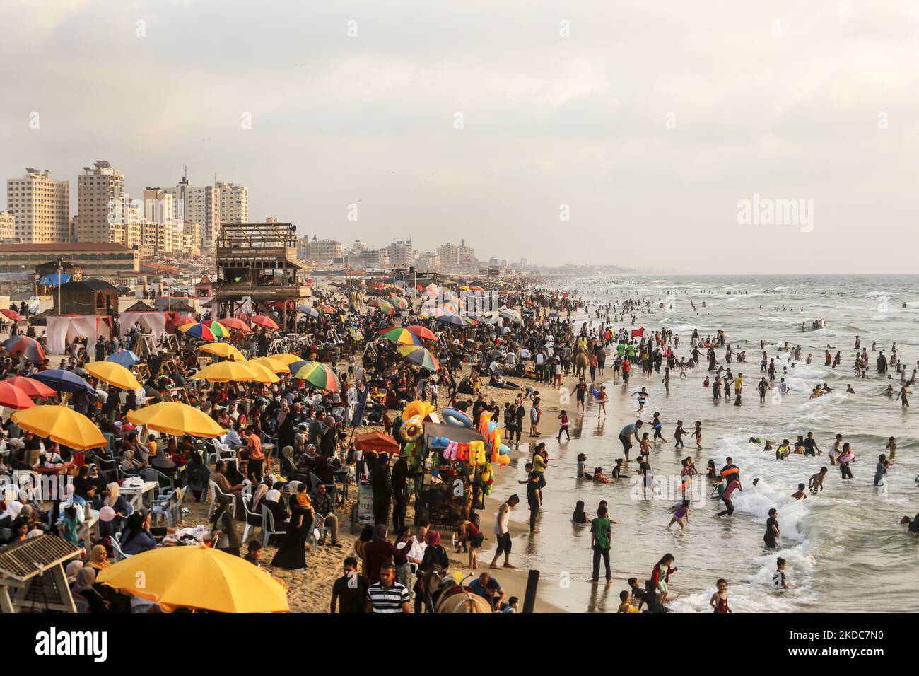 Hunderte von Palästinensern versammeln sich am 17. Juni 2022 in Gaza Beach, um sich an einem heißen Tag bei Sonnenuntergang abzukühlen. Die Strandbesucher im verarmten und belagerten Gazastreifen hatten zum ersten Mal seit Jahren die Chance, sauberes und sicheres Meerwasser zu genießen. (Foto von Sameh Rahmi/NurPhoto) Stockfoto