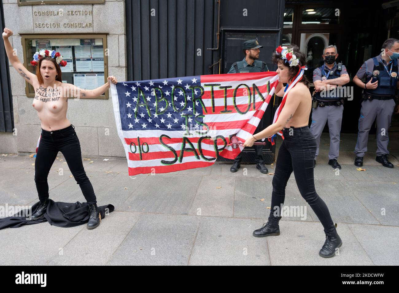 (ANMERKUNG DER REDAKTION: Bild enthält Nacktheit) zwei FEMEN-Aktivisten protestieren mit einem Transparent "Abtreibung ist heilig" oben ohne vor der US-Botschaft in Madrid. Aktivisten der internationalen feministischen Vereinigung FEMEN protestieren vor der Botschaft der Vereinigten Staaten von Amerika in Madrid, Spanien, gegen die Entscheidung des Obersten Gerichtshofs der USA gegen die freiwillige Unterbrechung der Schwangerschaft. Die Aktivisten zeigten ihre Brüste und trugen ein Transparent mit der Aufschrift „Abtreibung ist heilig“ am 27. Juni 2022 in Madrid, Spanien. (Foto von Oscar Gonzalez/NurPhoto) Stockfoto