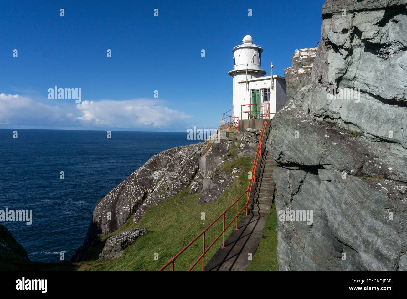 Weißer Leuchtturm am Felskante am atlantischen Ozean in irland Stockfoto