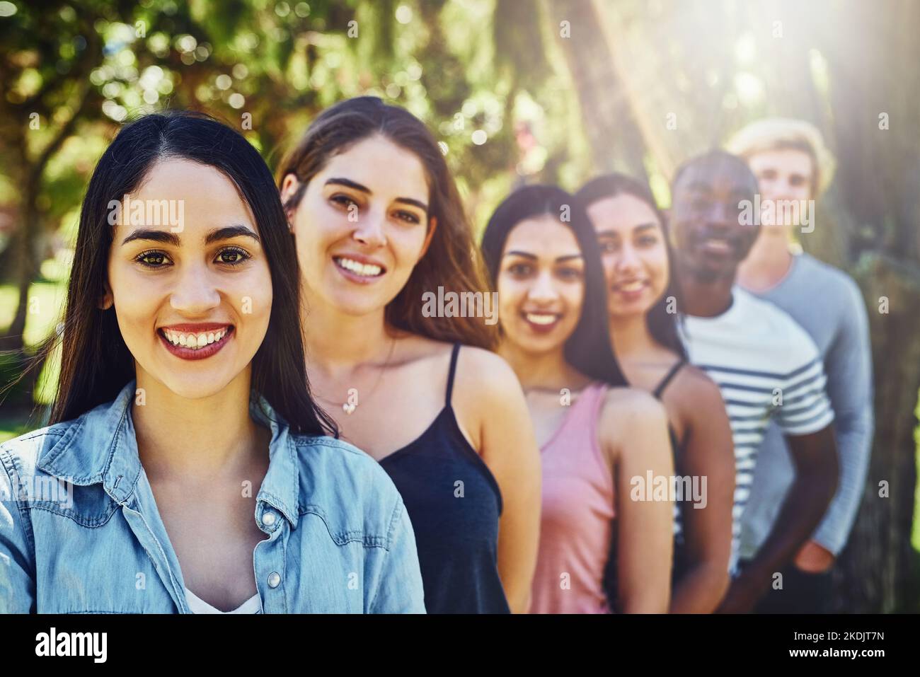 Ich habe die größte Gruppe von Freunden hinter mir. Porträt einer Gruppe von Freunden, die in einer Reihe im Freien stehen. Stockfoto