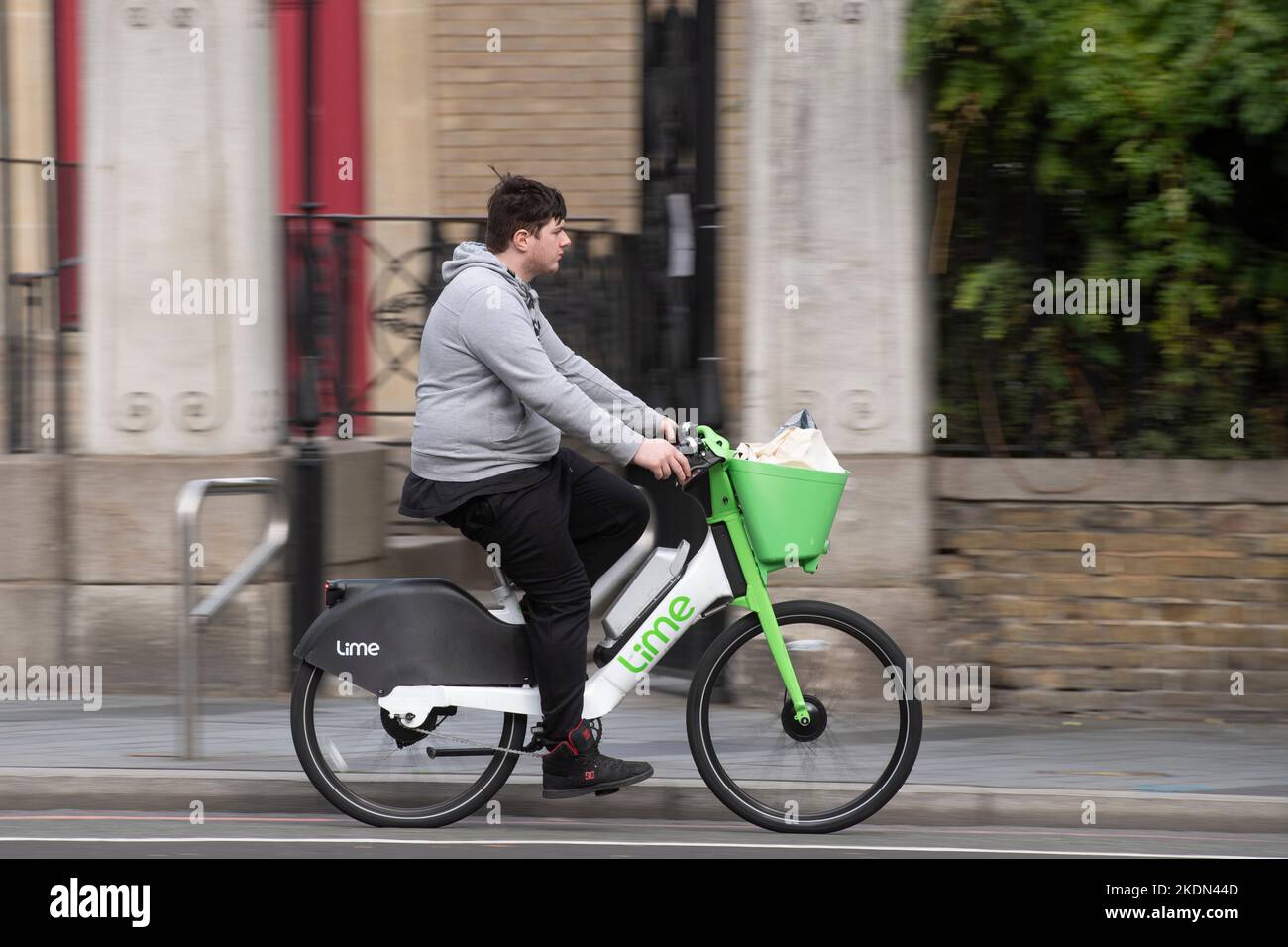 Ein Mann, der auf einem Lime-Elektrofahrrad entlang der Waterloo Road, London, Großbritannien, fährt. 16 Okt 2022 Stockfoto