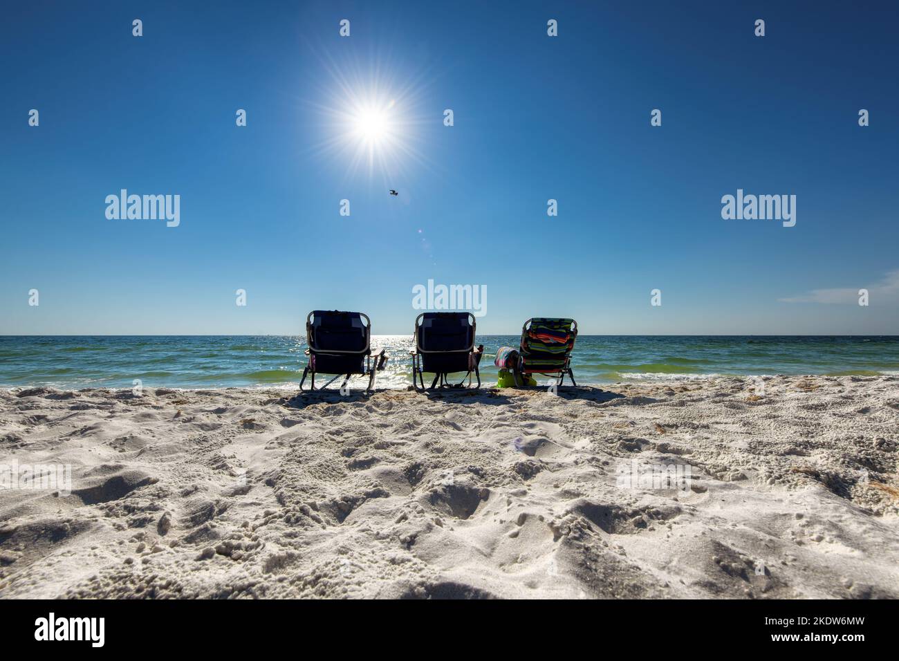 Sonniger tropischer Strand und Liegestühle in weißem Sand Stockfoto