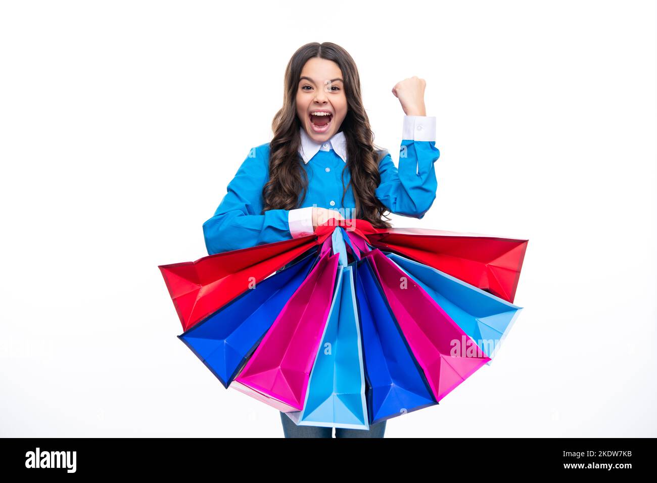 Aufgeregtes Gesicht. Schöne Mode Teenager Mädchen mit Einkaufstaschen auf weißem Hintergrund. Shopaholic Shopping und Mode. Kind mit Einkaufsverkauf Stockfoto