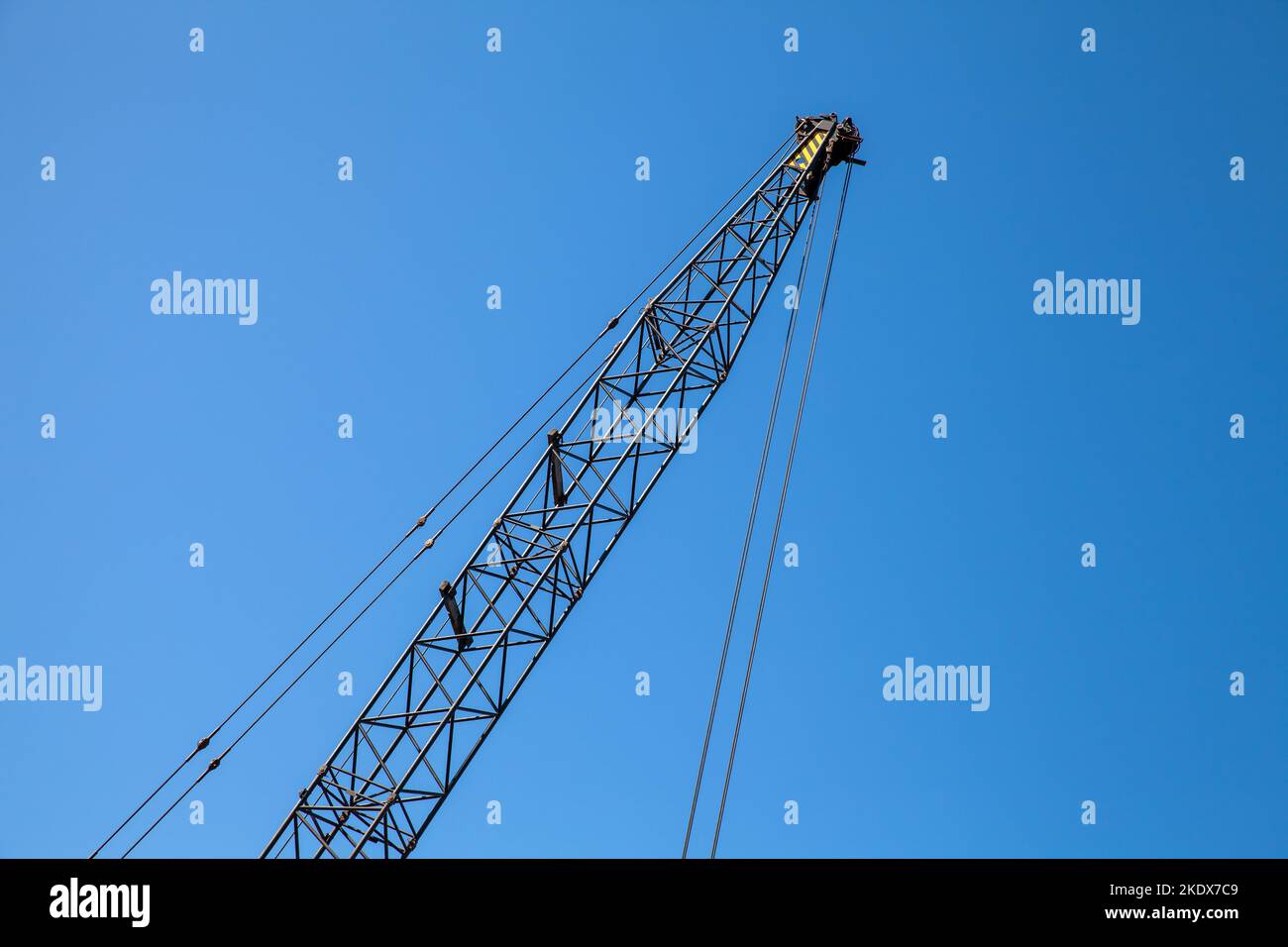 Der Kranausleger steht tagsüber unter blauem Himmel Stockfoto