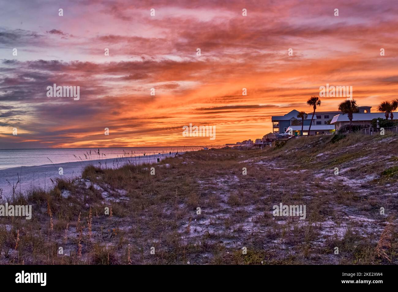 Florida Stranduntergang in der Nähe von Destin Florida, USA, an der Florida Golfküste oder Panhandle, mit Sanddünen und Seeoaten im Vordergrund. Stockfoto