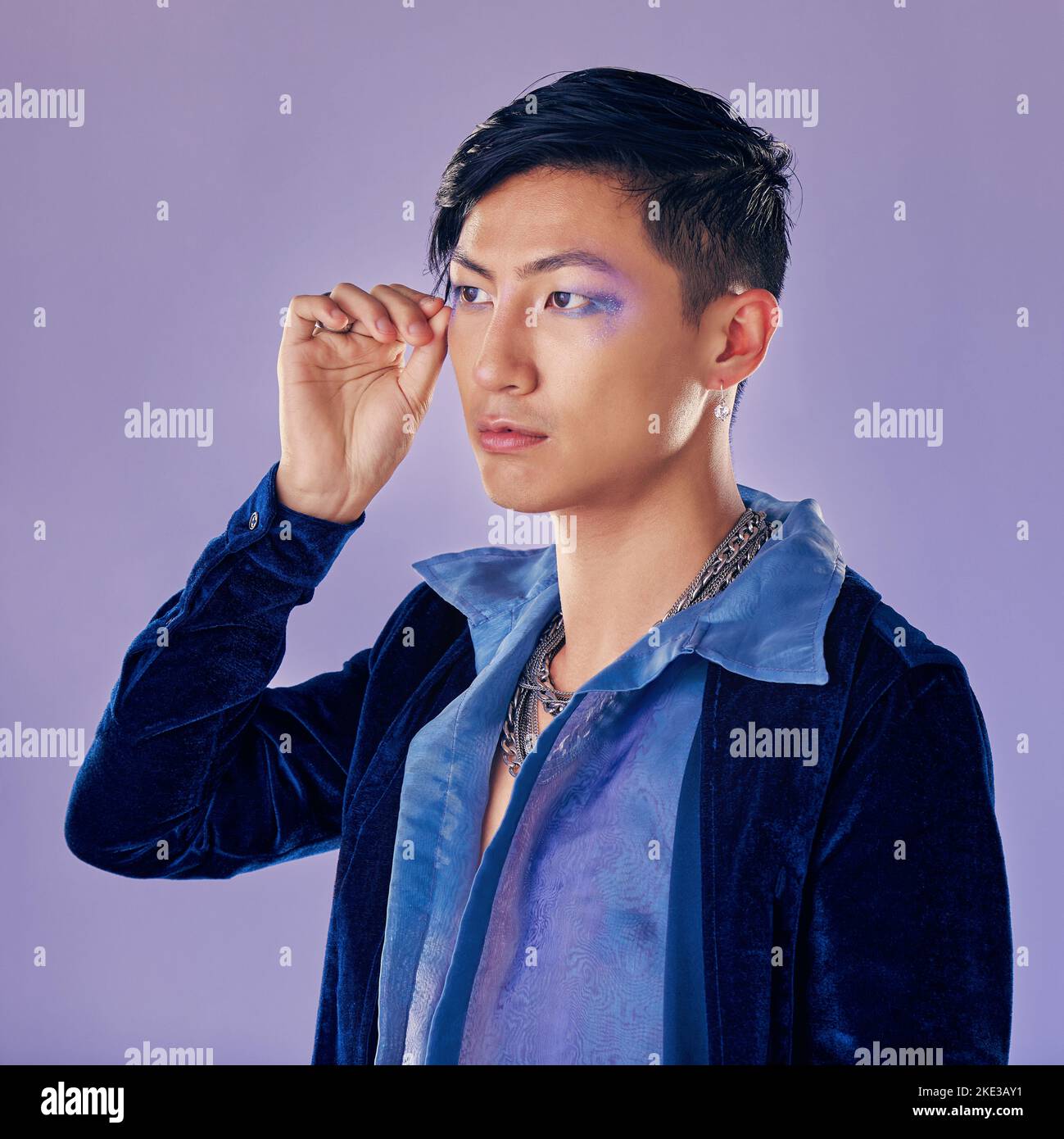 Punk-, Rock- oder schwuler Mann mit Lidschatten, Make-up und Kosmetik, Vintage- oder Retro-Mode auf purpurem Hintergrund für Pop-Art-Style. Asiatische lgbtq Stockfoto