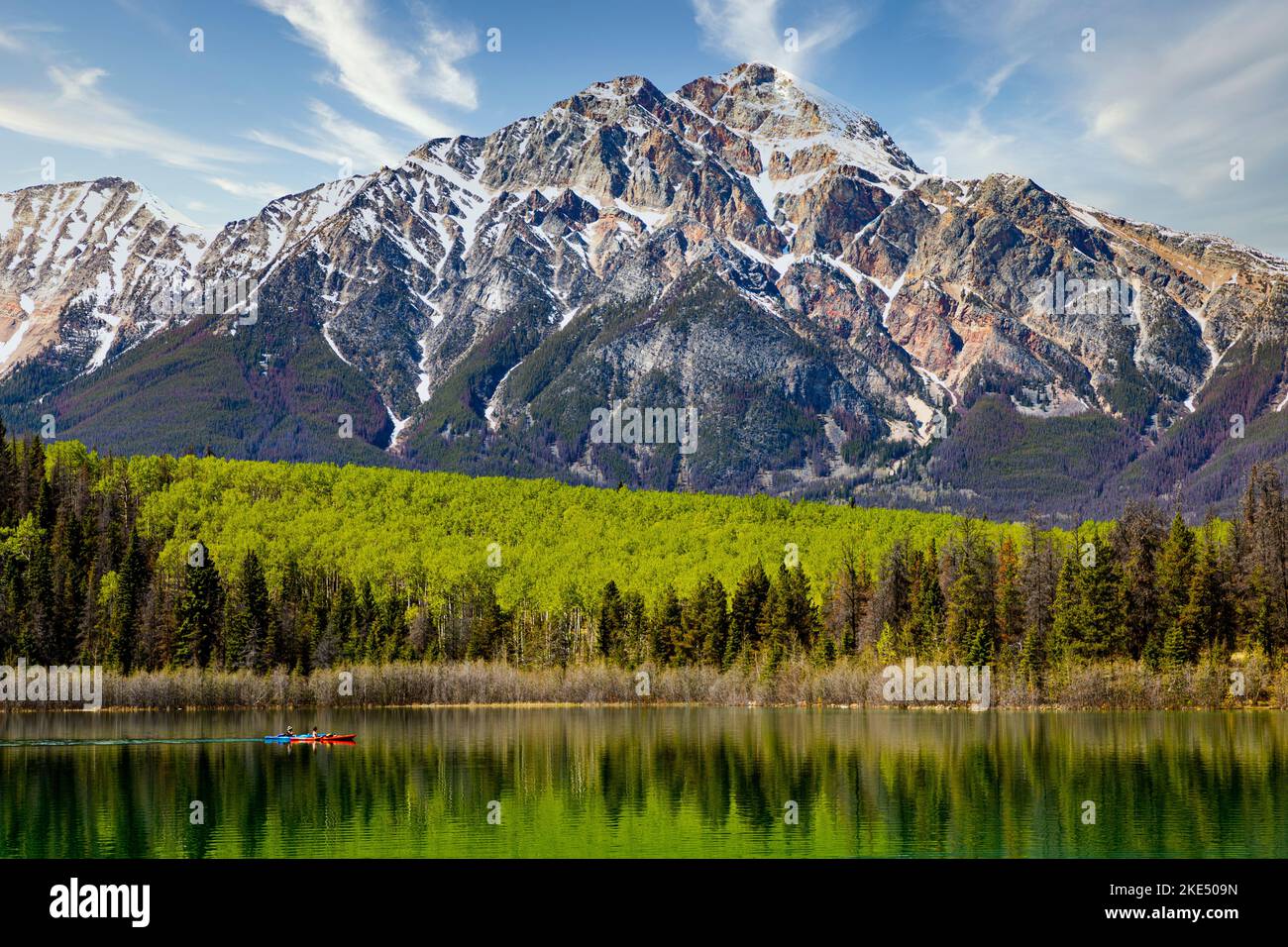 Der Patricia Lake spiegelt das üppige Grün mit dem Pyramid Mountain und dem blauen Himmel darüber wider Stockfoto