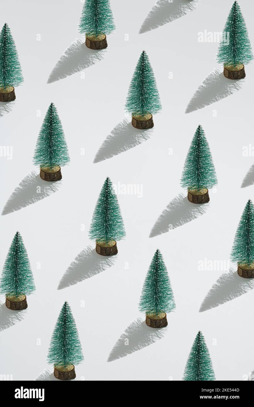 Minimale Zusammensetzung Muster Hintergrund von grünen Weihnachtsbäumen auf weißem Hintergrund. Neujahrskonzept. Stockfoto