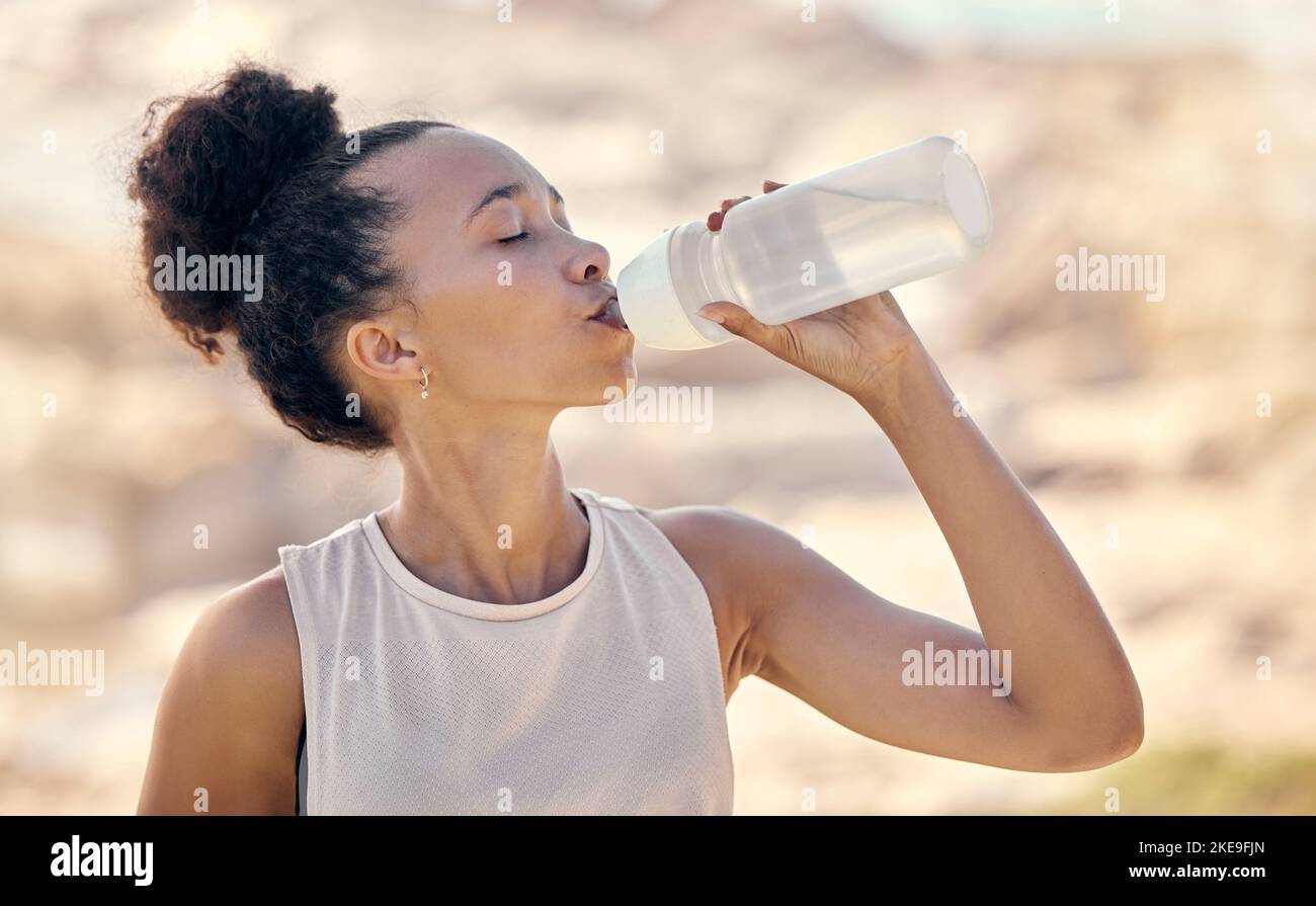 Fitness, Wellness und schwarze Frau trinken Wasser nach dem Training, Training und Training in der Natur, Park und im Freien. Hydratation, Gesundheit und Durst Stockfoto