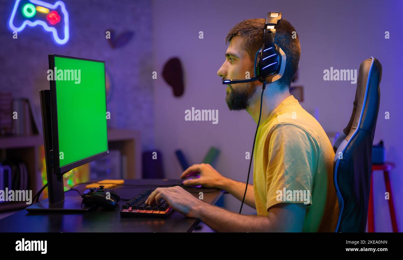 Pro Gamer streamen Videospiele mit Green Screen Mock-up-Display im Gaming-Heimstudio. Chroma-Taste. Stockfoto
