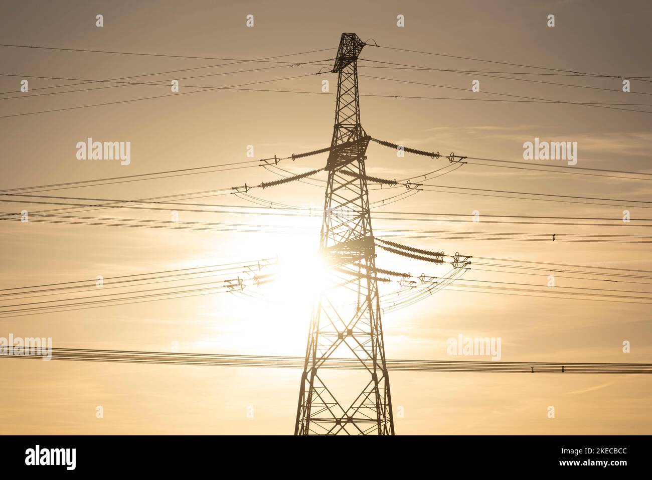 Grelles Sonnenlicht scheint über einem Strommast. Stockfoto