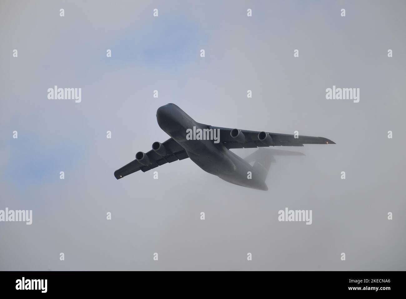 Die US Air Force C-5 Galaxy verlässt MCAS Miramar durch die Wolkendecke Stockfoto