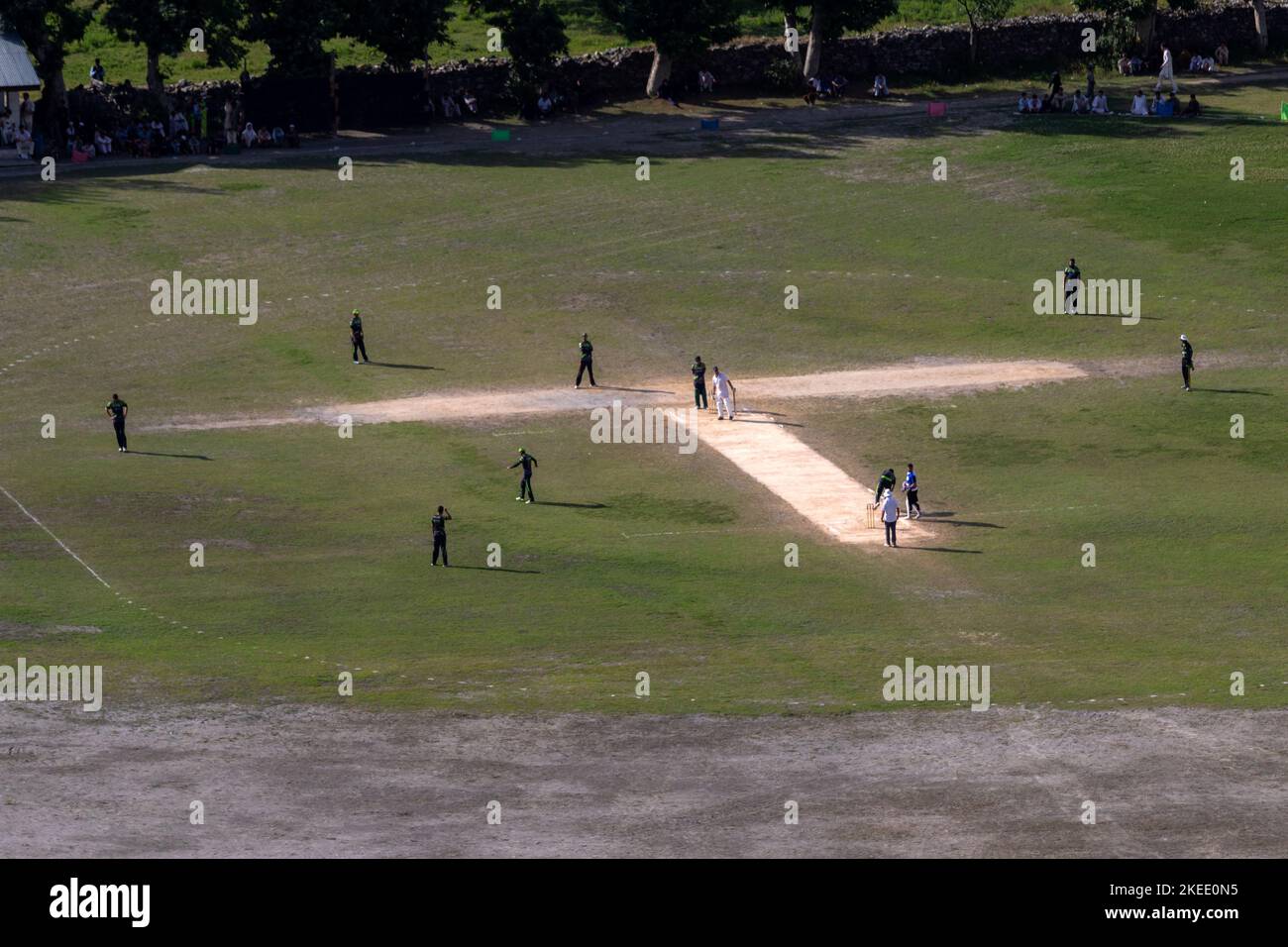 Die Jungs spielen auf dem Cricketplatz Stockfoto