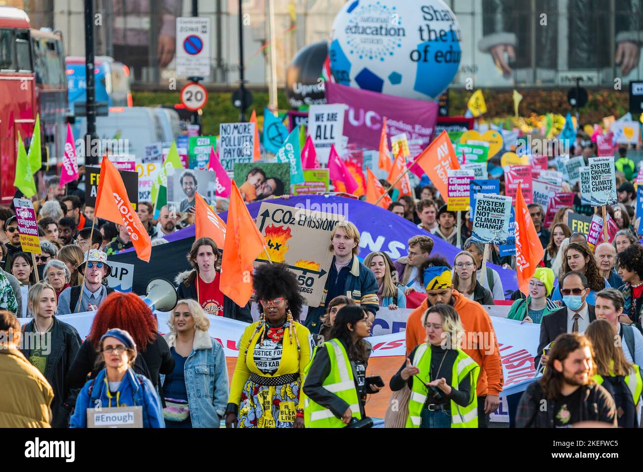 London, Großbritannien. 12.. November 2022. Unterstützer von Justice for Chris Kaba schließen sich dem marsch an Saying Climate Justice means Racial Justice - Ein klimamarsch auf den Trafalgar Square mit verschiedenen Umweltgruppen, darunter der Climate Reparations Bloc, und definanzieren das Klima-Chaos. Sie fordern: 1) Stopp der Versicherung und Finanzierung von Projekten für fossile Brennstoffe 2) Stopp der Ostafrikanischen Rohöl-Pipeline (EACOP) und Stopp von Rosebank-Ölfeld, 3) Klimareparationen für Gemeinden weltweit. Kredit: Guy Bell/Alamy Live Nachrichten Stockfoto