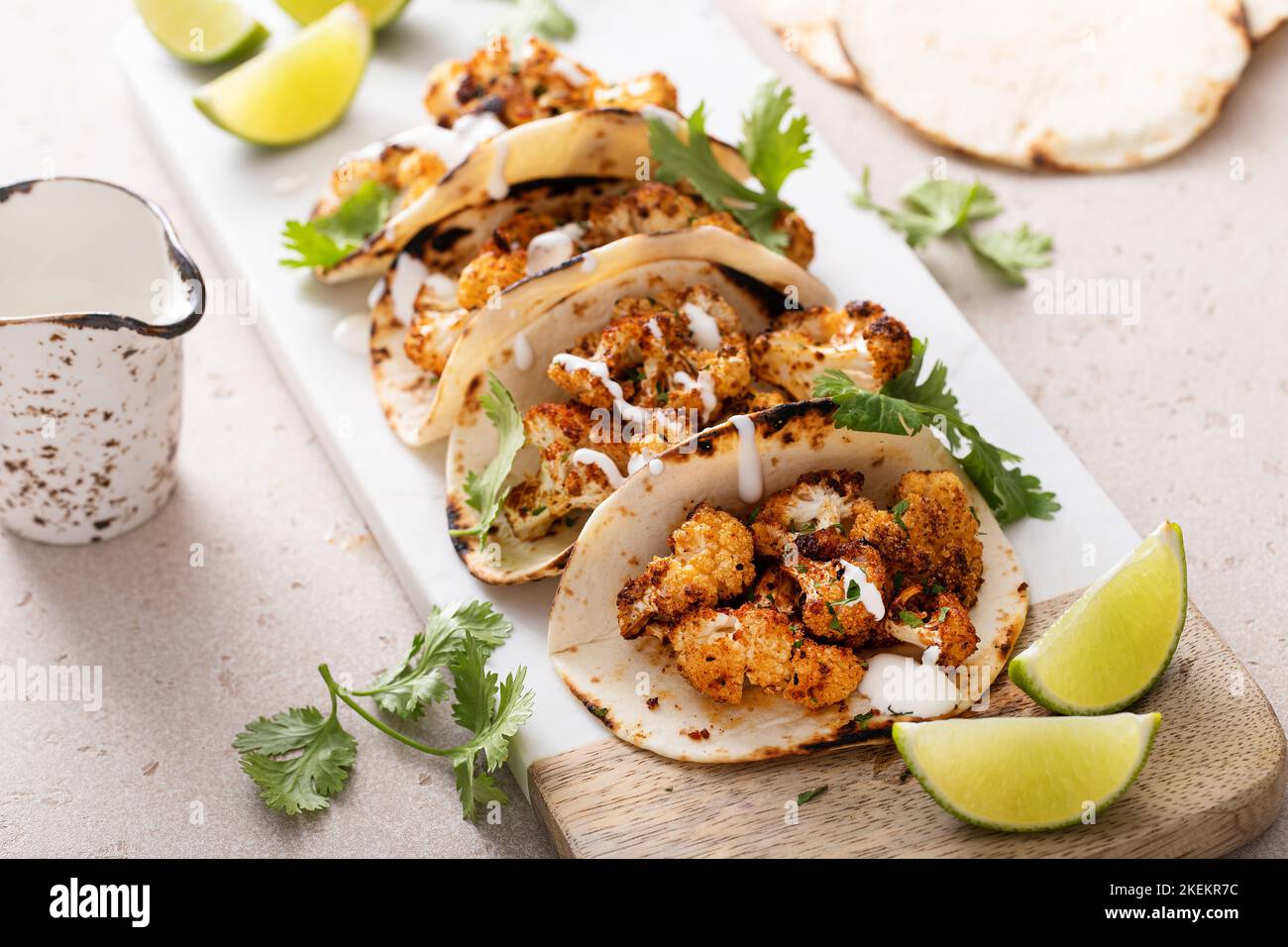 Würzige Blumenkohl-Tacos mit Koriander und mexikanischer Crema Stockfoto