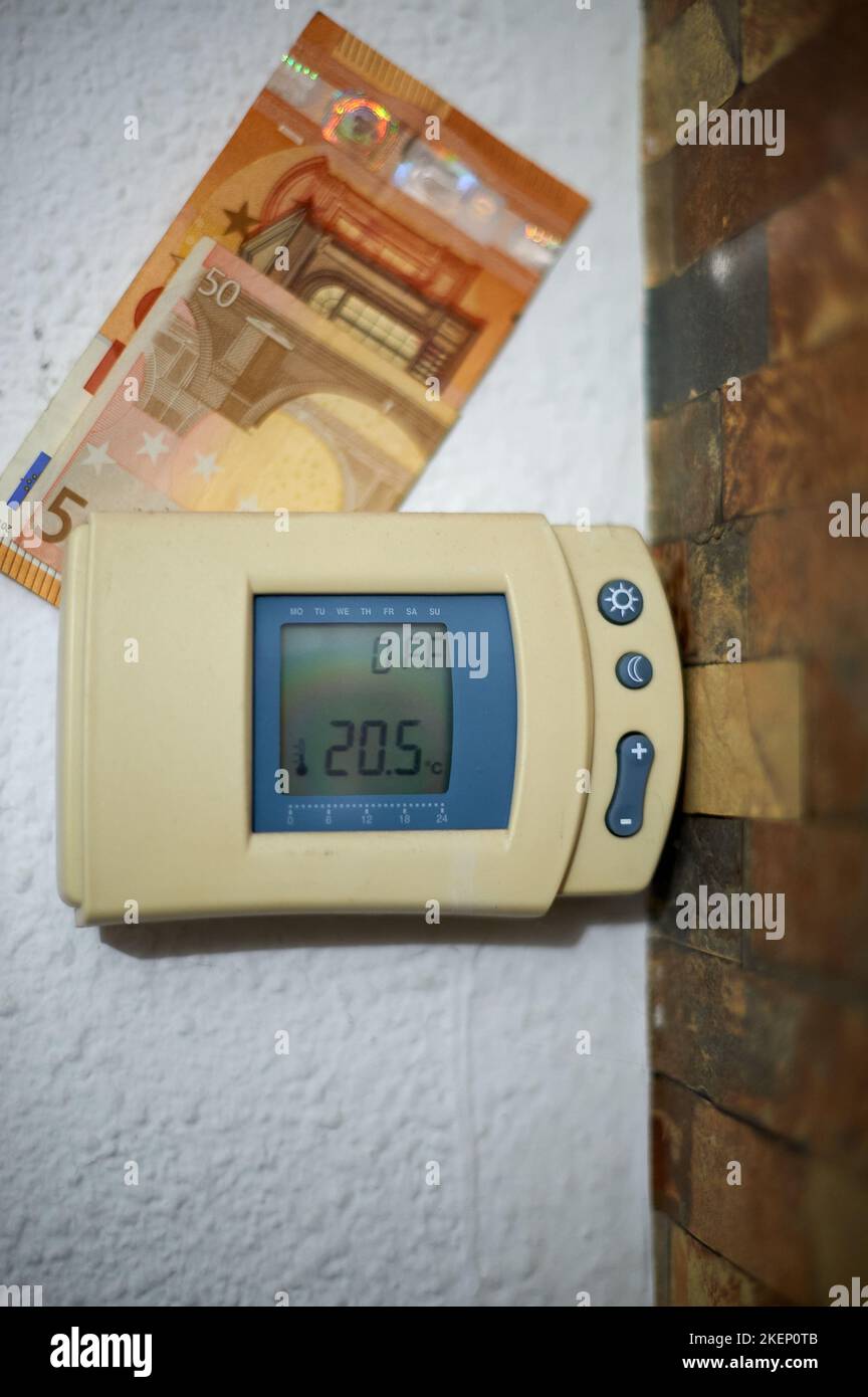 Heizthermostat-Controller mit Euro-Bargeld auf der Oberseite an einer Wand eines Hauses. Stockfoto