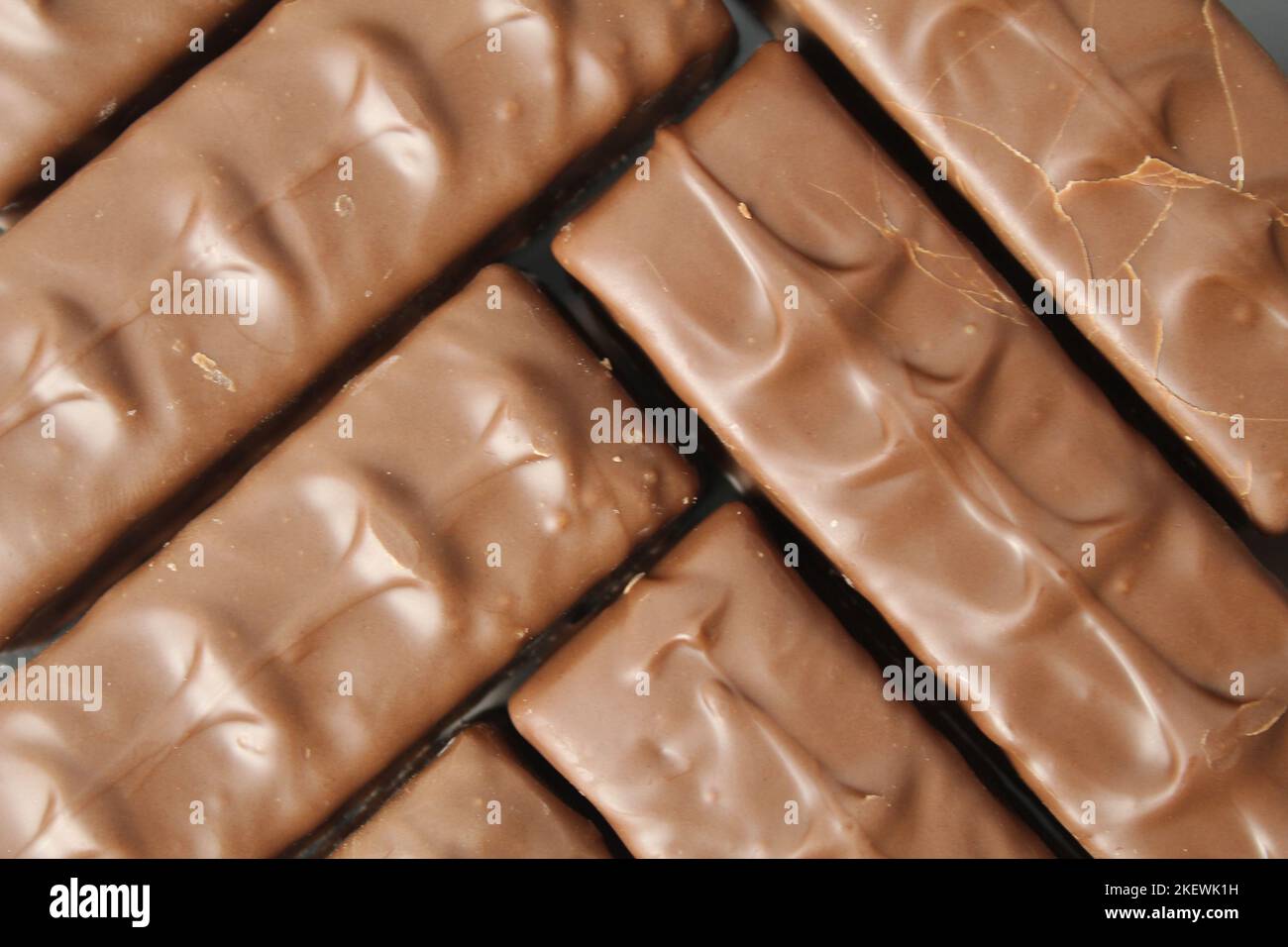 Background Food aus Schokoladenriegeln Tag Schokoladenbonbons Tag ohne Diät. Köstlicher Hintergrund. Stockfoto
