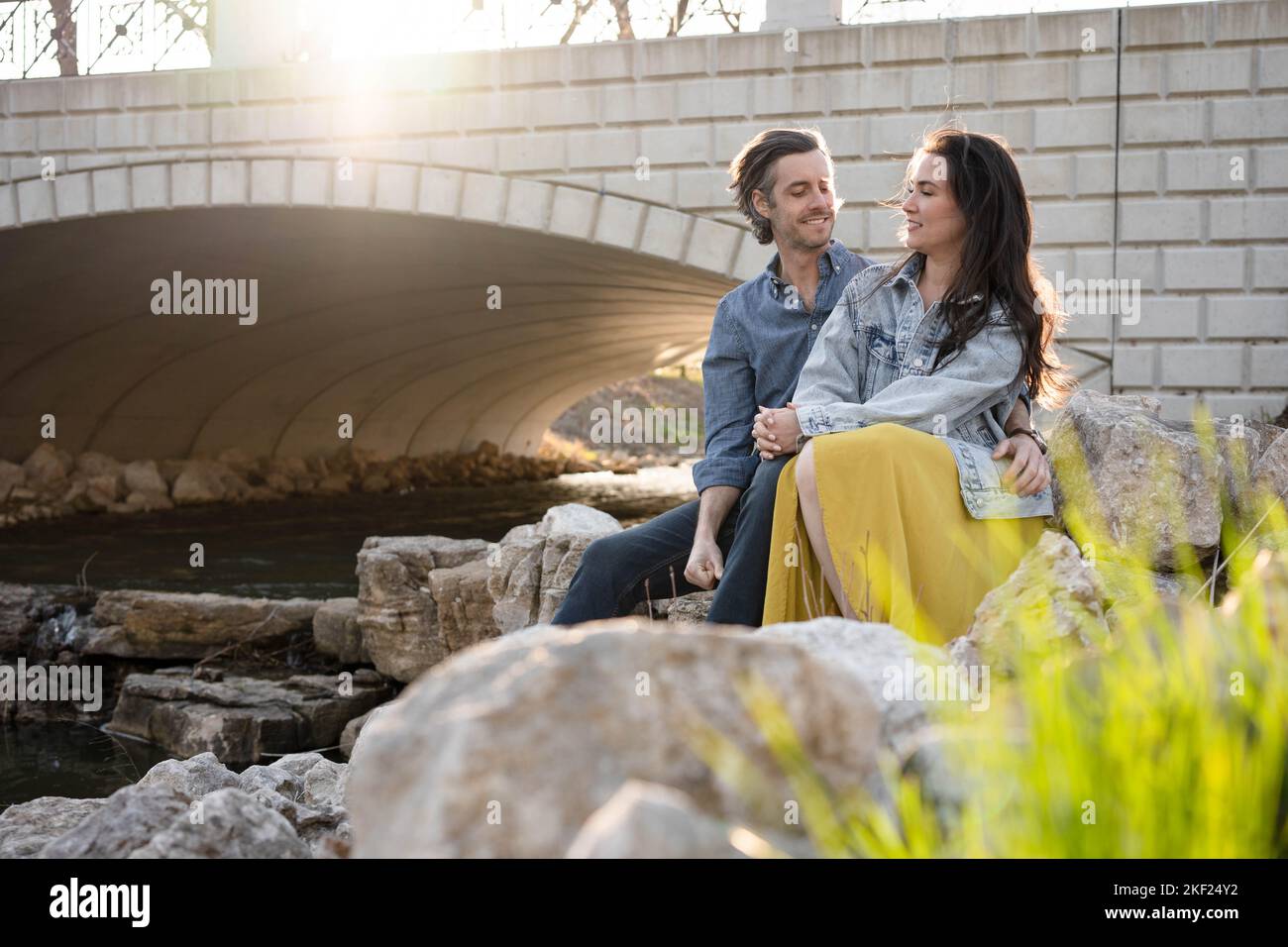 Ein Paar an einer Brücke im Forest Park, flirtet und erkundet zusammen. Stockfoto