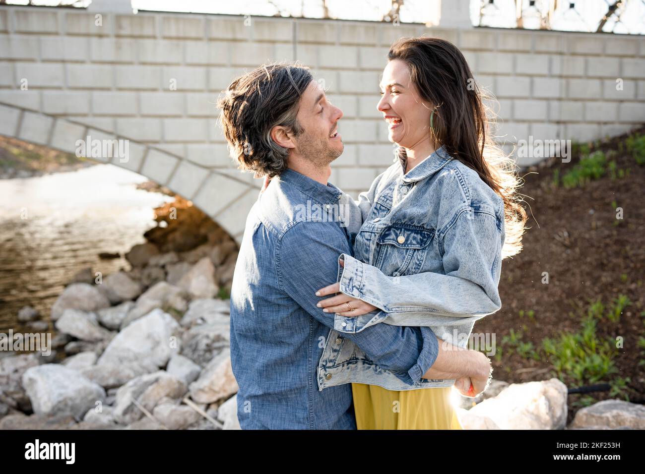 Ein Paar an einer Brücke im Forest Park, flirtet und erkundet zusammen. Stockfoto