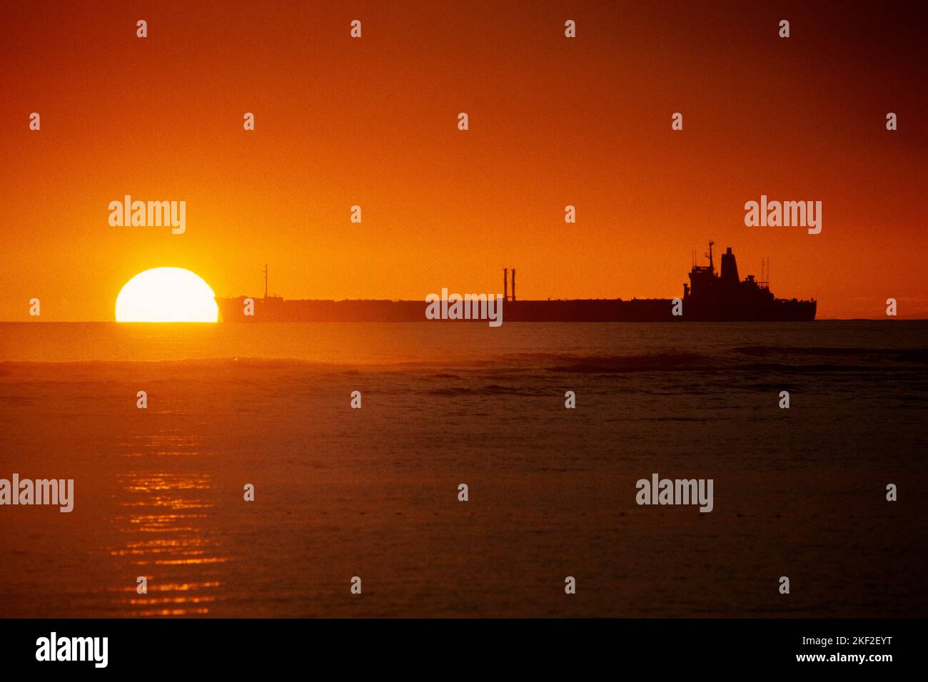 1980S BULK-CONTAINERSCHIFF LEBENSADER IN DEN REST DER WELT VOR SONNENUNTERGANG HAWAII USA PASSIEREN - KS26723 LSS001 HARS MORNING NORDAMERIKA NORDAMERIKANISCHER CONTAINER WEITWINKEL KRAFTVOLLER INNOVATIONSSTOLZ STIMMUNG AM ENDE DES TAGES AMBER HI BULK KONZEPTIONELL SONNENAUFGANG DÄMMERUNG LIEFERN DÄMMERUNG MOONLIGHT LIFELINE TANKER HANDEL CONTAINERSCHIFF RIESIGE PRÄZISION VERSAND DÄMMERUNG ALTMODISCH Stockfoto