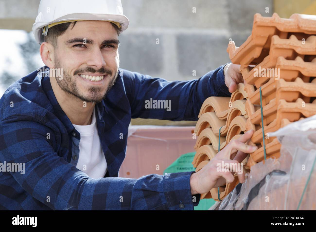 Dachdecker Bauarbeiter zwischen Fliesen Stockfoto