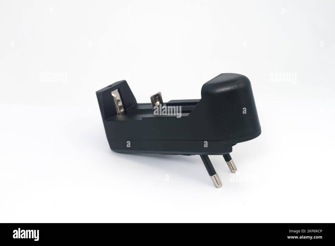 Ein einzelnes AA- oder AAA-Akkuladegerät auf weißem Hintergrund. Stockfoto