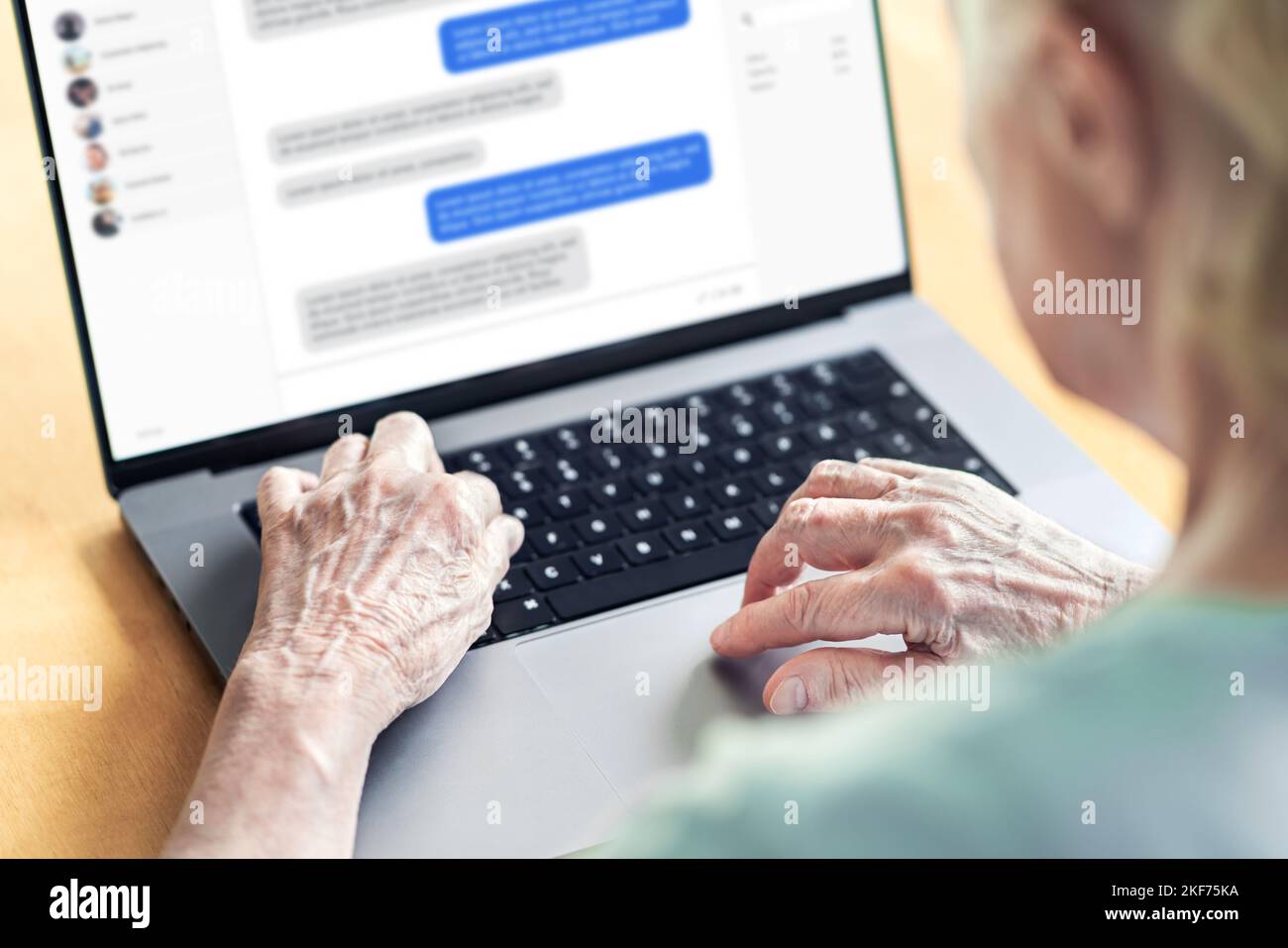 Chat-Nachrichten im Laptop einer alten Frau. Liebe Betrug Wels. Ältere Person im Online-Gespräch mit der Familie. Großmutters Gruppennachrichten. Stockfoto