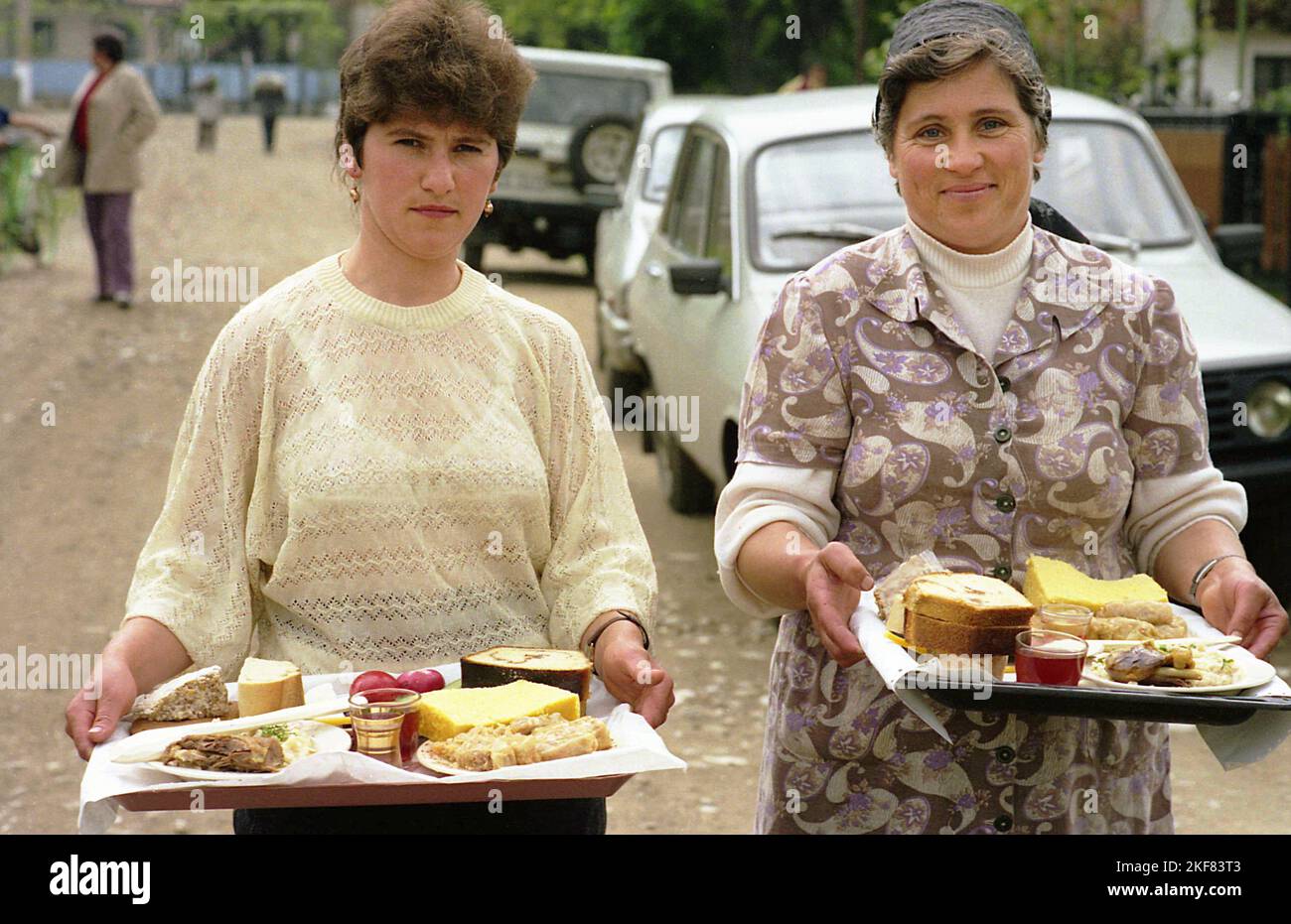 Ilfov County, Rumänien, 1991. Am Ostermorgen bringen einheimische Frauen Almosen zu ihren Nachbarn, eine Tradition für die Seelen der Verlorenen. Stockfoto