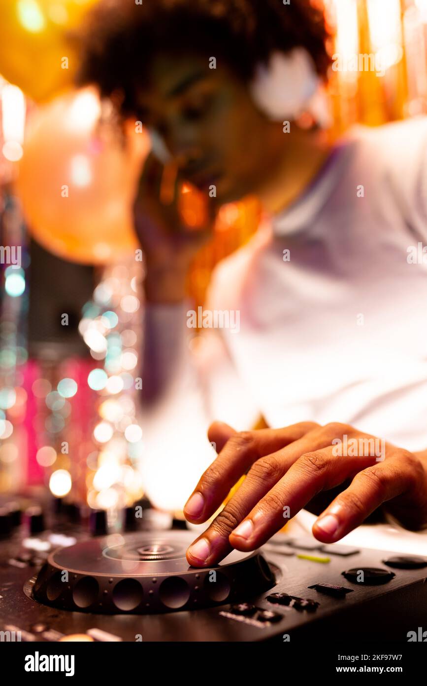 Vertikales Bild eines afroamerikanischen djs, der Musik in einem Nachtclub spielt, selektiver Fokus Stockfoto