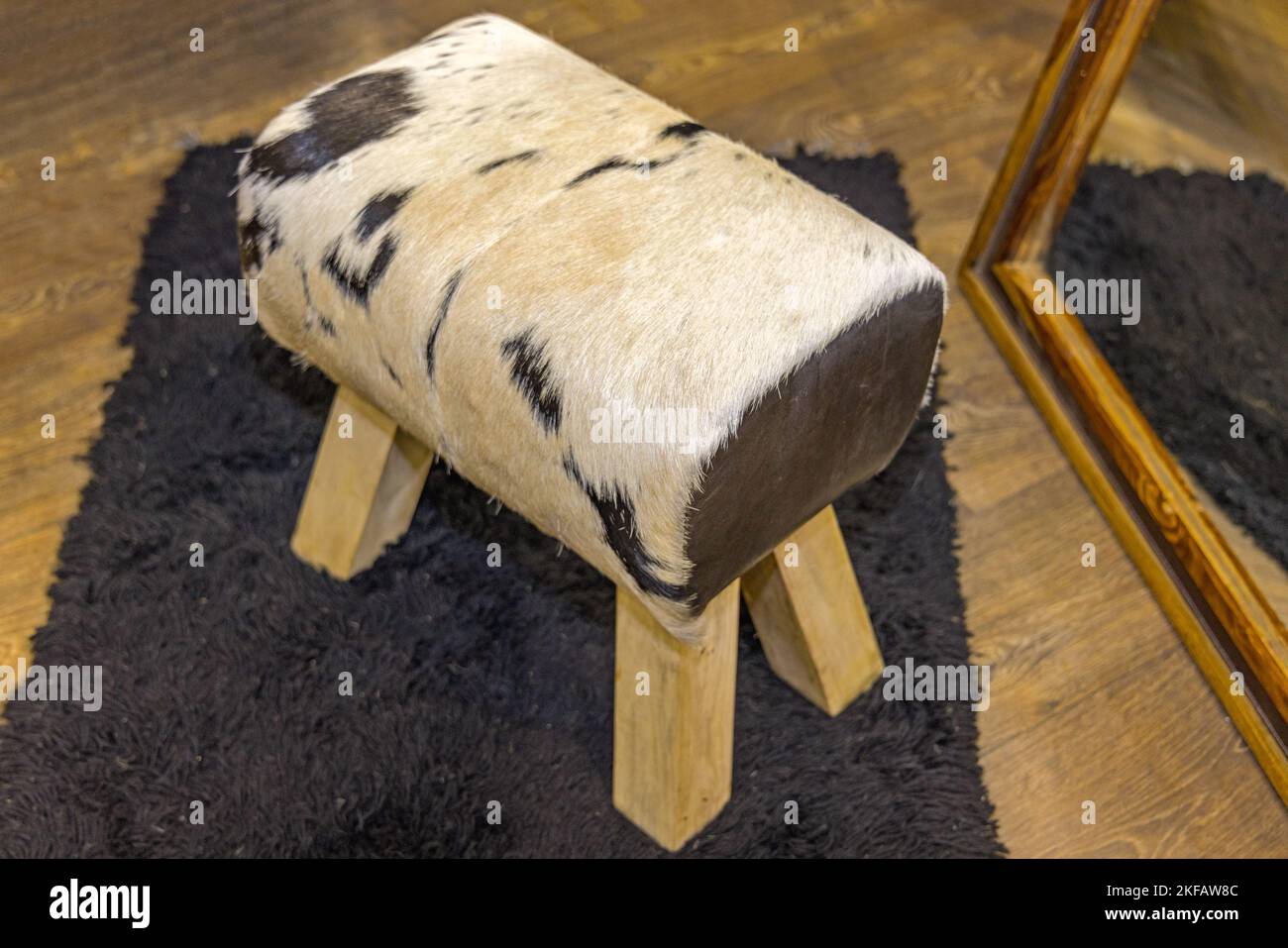 Cowhide Hocker Cowboy Style Möbel für Classic Cabin Stockfoto