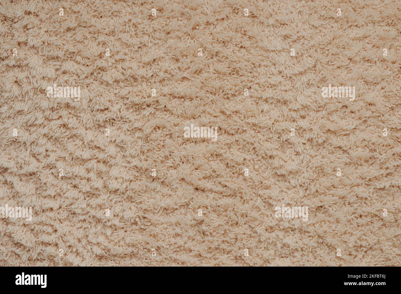 Beigefarbenes Tuch Teppich Hintergrund. Weicher, nahtlos warmer Fleeceteppich Stockfoto