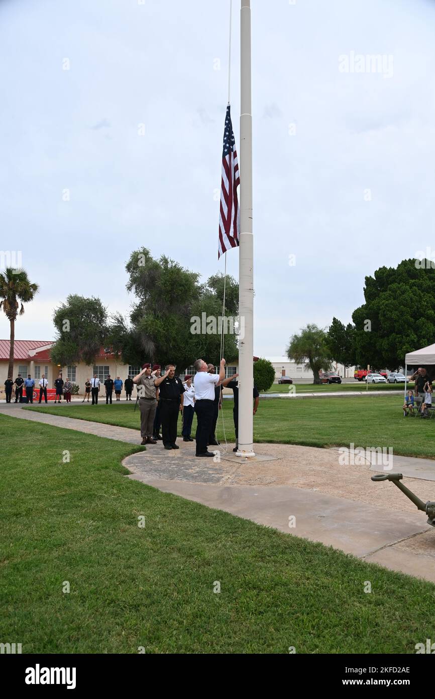 Während einer Gedenkfeier zum Patriot Day am 8. September 2022 senkte eine Ehrengarde, bestehend aus Soldaten der Yuma Proving Ground (YPG) der US Army, Polizisten und Feuerwehrleuten, die amerikanische Flagge auf Halbmast, während Dutzende von YPG-Mitarbeitern auf den Blick blicken. Das Geräusch eines leichten Regens, der auf die Baldachine über Klappstühlen für das Publikum fiel, war das einzige Geräusch, das zu hören war. Patriot Day, USA Army Yuma Proving Ground, Yuma Proving Ground, Stockfoto