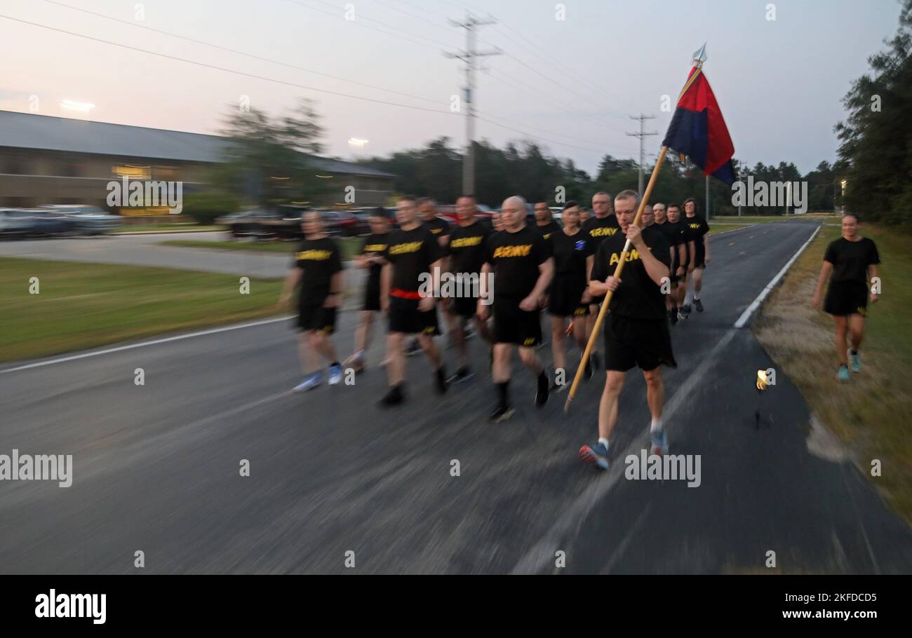 US Army Reserve Chief Warrant Officer 2 Donald Smith tritt mit dem Leitfaden der 88. Readiness Division zurück, als die Hauptquartier- und Hauptquartierabteilung marschierten, um den 9/11 Hero Memorial 5K Run/Walk in Fort McCoy, Wis., am 9. September 2022 zu starten. Das Ereignis, das vor Sonnenaufgang begann, förderte Esprit de Corps und ehrte alle Helden von 9-11, einschließlich Dienstmitgliedern und Ersthelfern, die das ultimative Opfer zahlten. Stockfoto