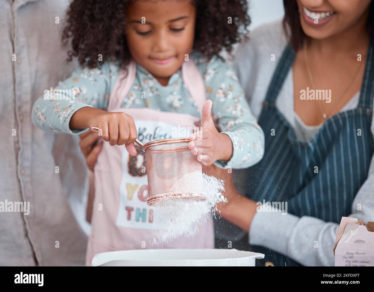 Hände, Kinder und Backen mit einem Mädchen lernen, wie man in der Küche ihres Hauses mit Mutter backen. Mehl, Kinder und Kochen mit einem weiblichen Kind und Stockfoto