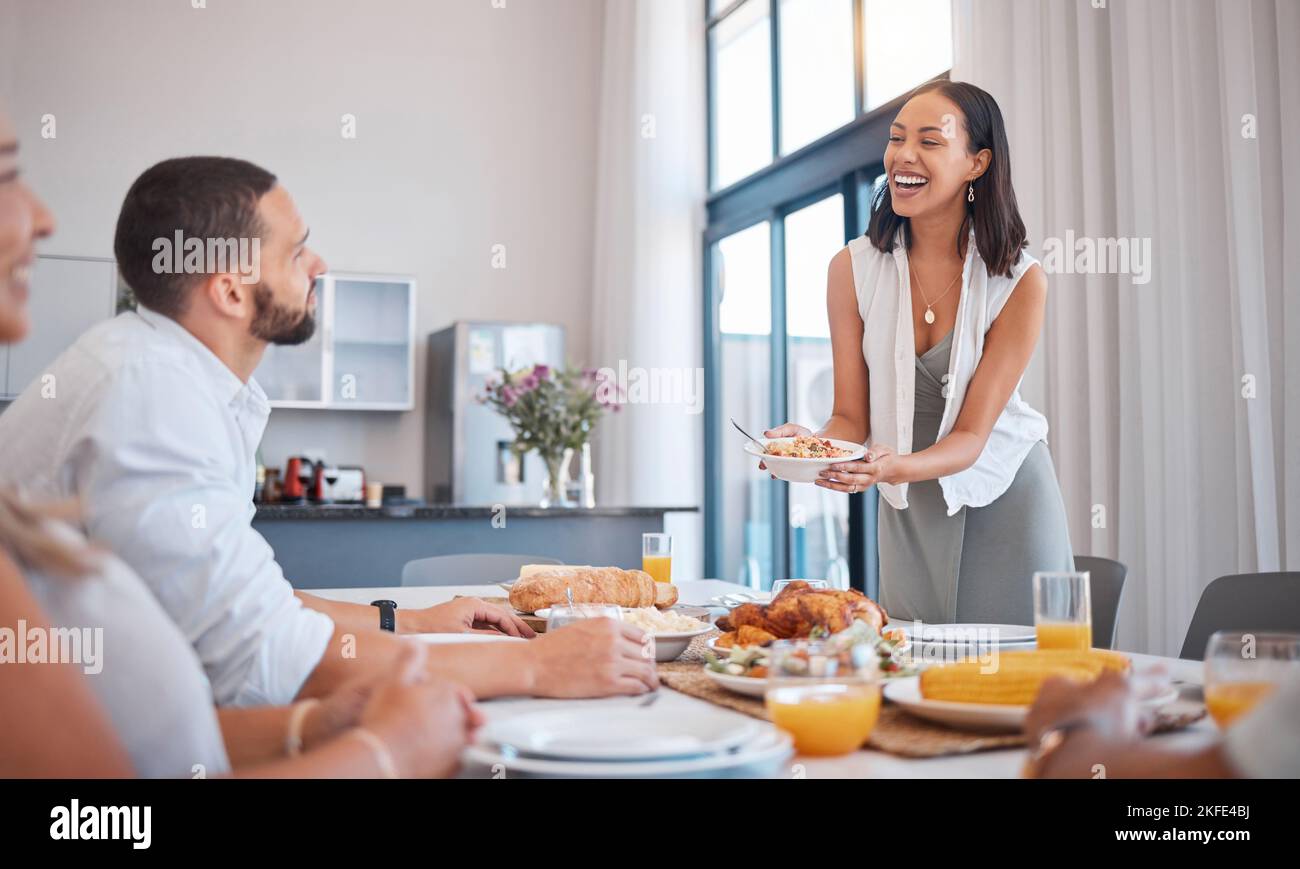 Familie, Freunde und Frau, die zu Weihnachten, Geburtstag oder am Wochenende ein Mittagessen servieren. Glückliche Familie, Männer und Frauen lächeln am Tisch essen und Stockfoto