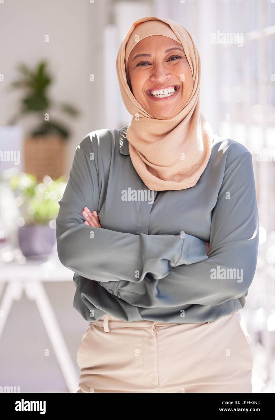 Erfolg, Führung und Porträt einer muslimischen Frau im Amt mit gekreuzten Armen, Lächeln und Selbstvertrauen. Empowerment, professionelle und glückliche Arbeitnehmerin Stockfoto